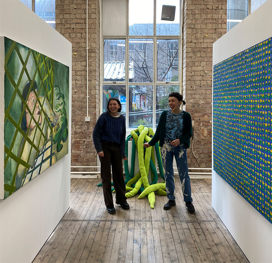 Artists Esther Castle and Tiree Taylor standing in front of their exhibition 'The Day We Lost the Wheelbarrow' at Summerhall, Invitro Gallery in Edinburgh. 