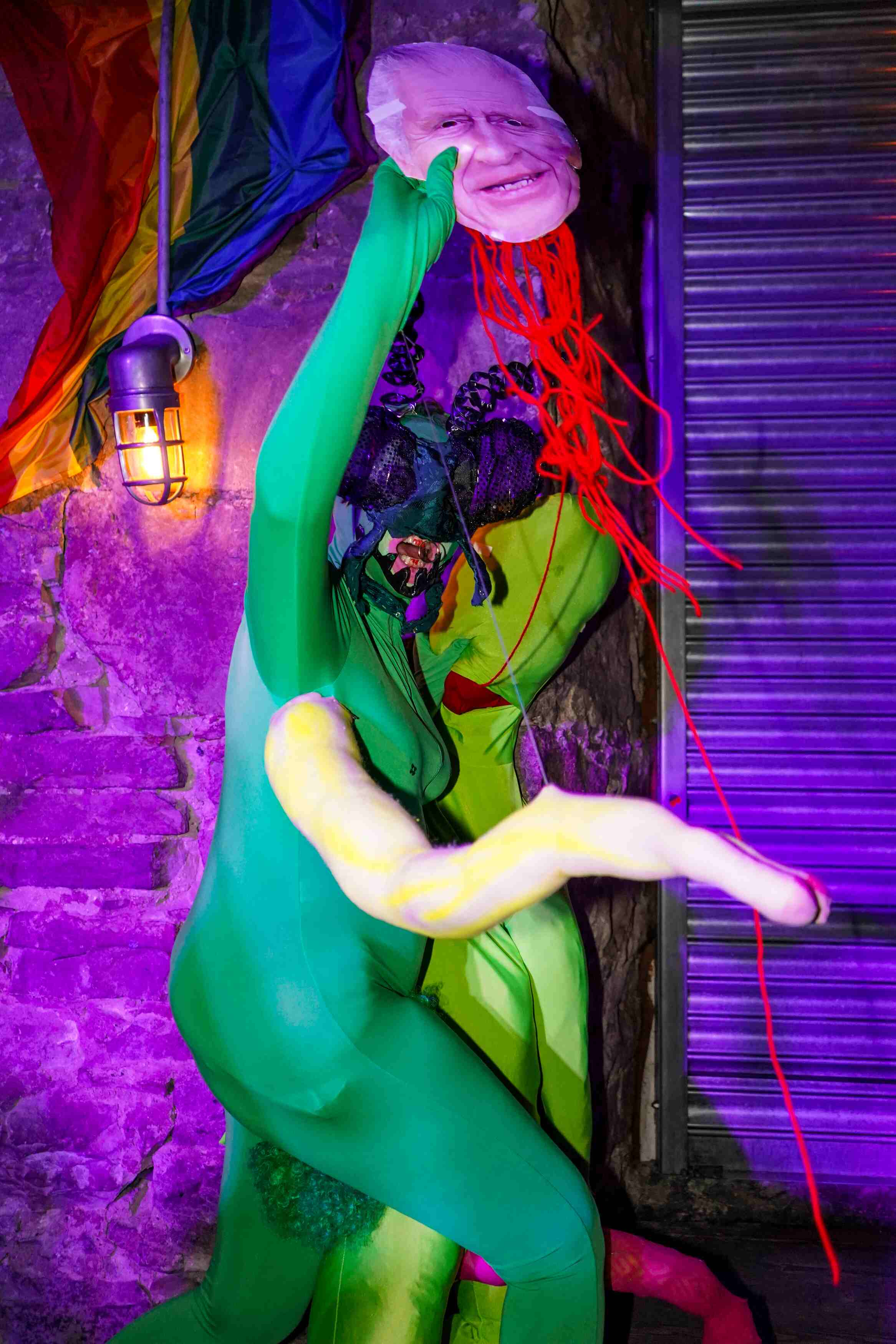 a drag creature praying mantis holding king charles decapitated head