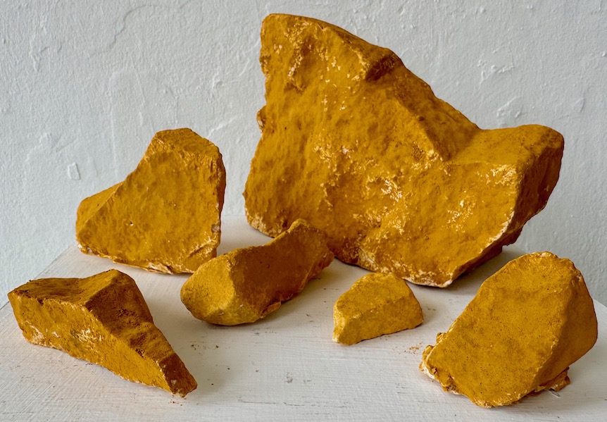 Rocks from the Radical Road, 2024. Yellow ochre pigment on plaster. 