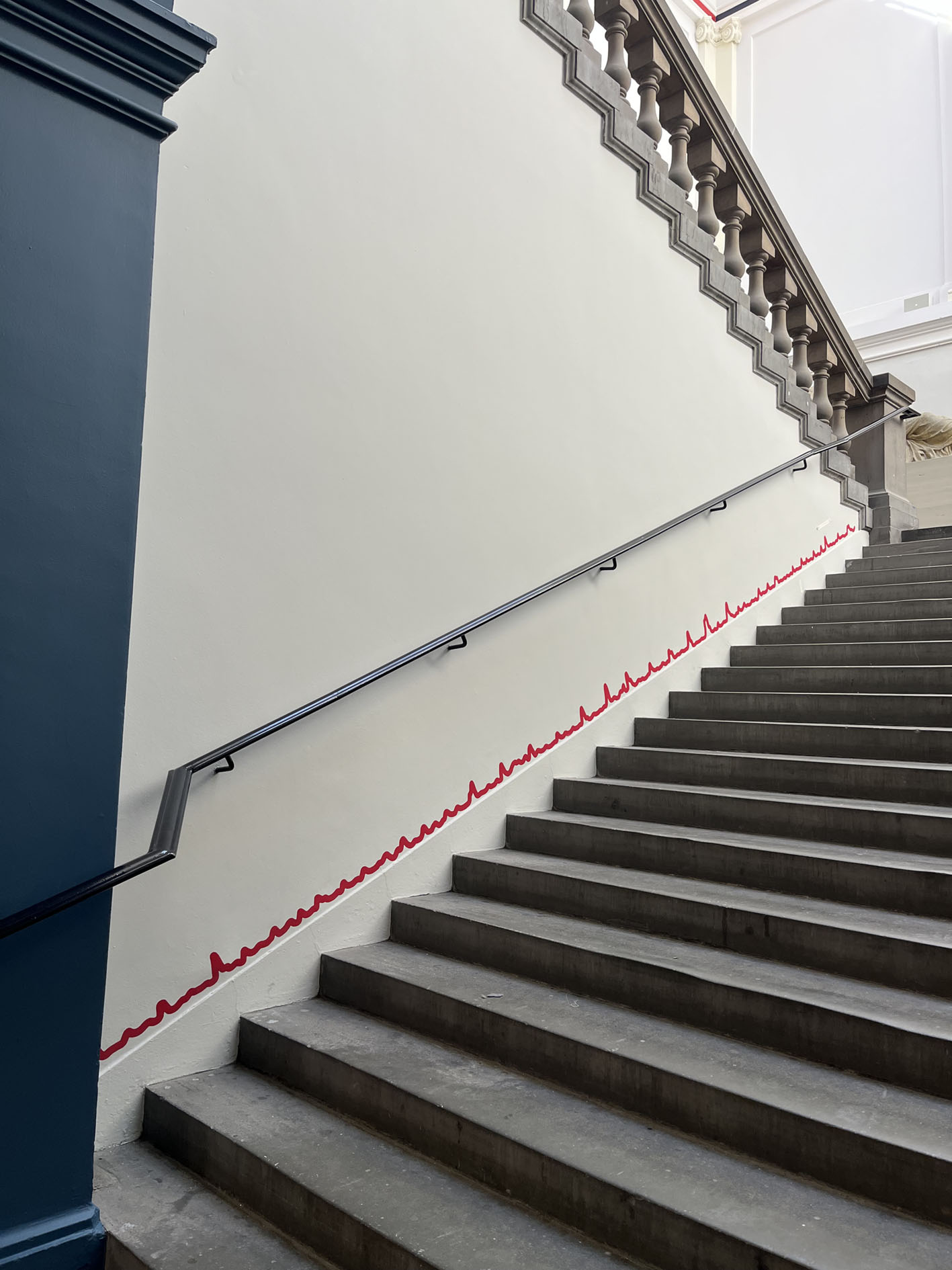 Red squiggly line running up the side of a staircase.