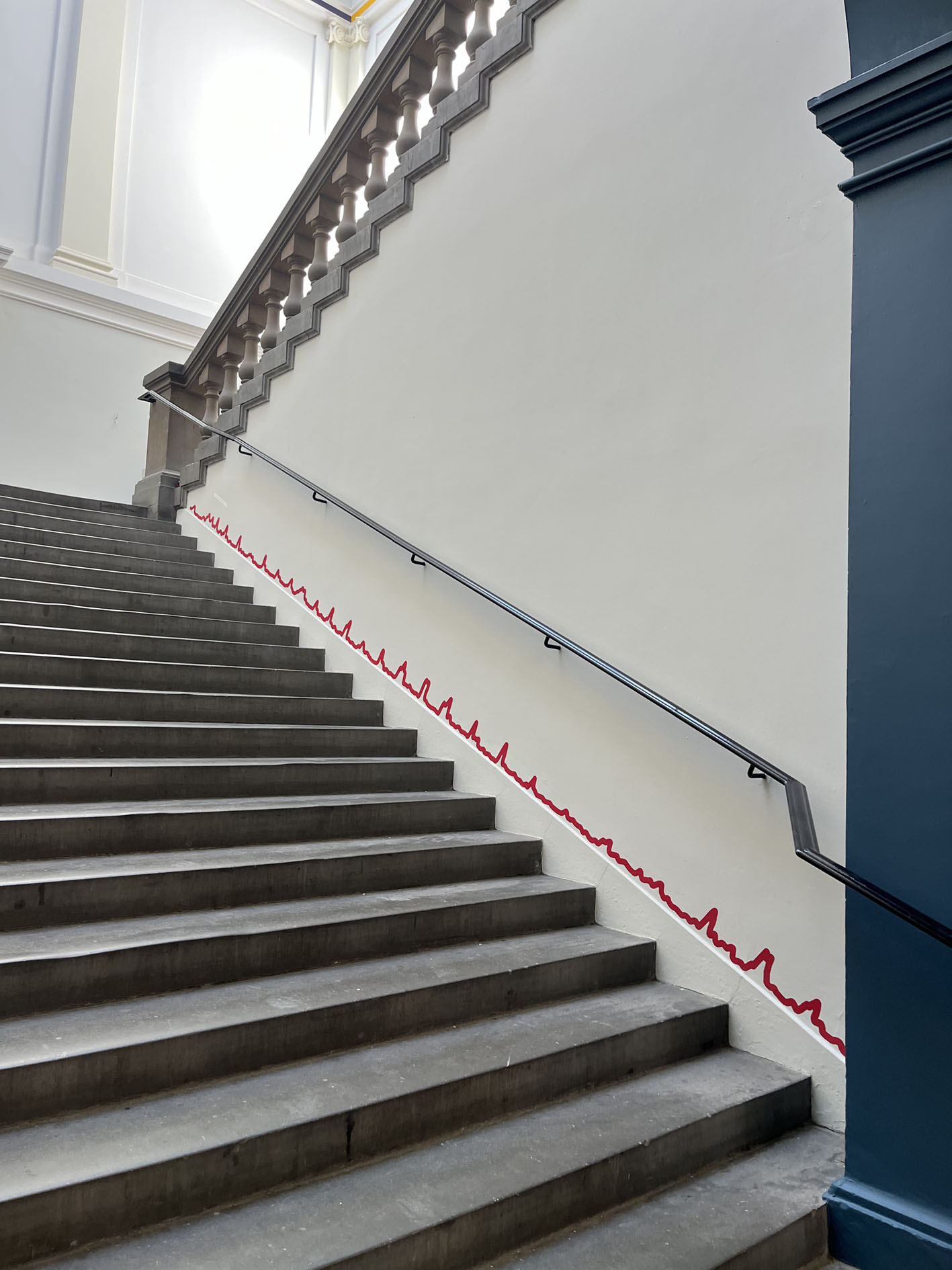 Red squiggly line running up the side of a staircase.