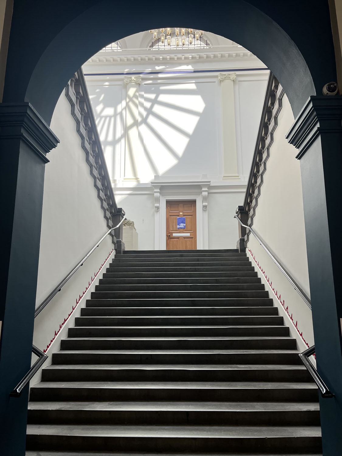 Thin red line along both sides of a staircase.