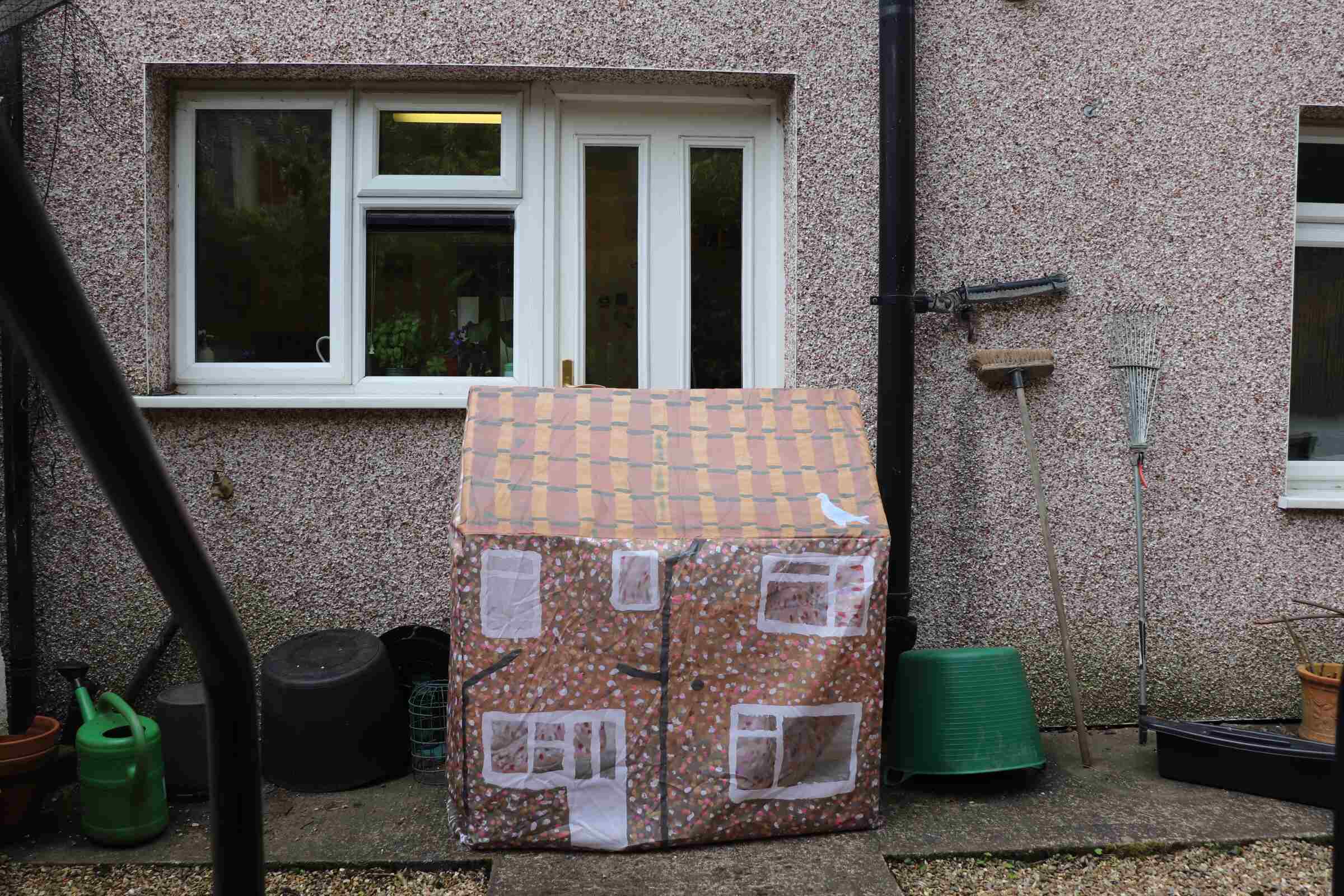 a small tent in front of a house