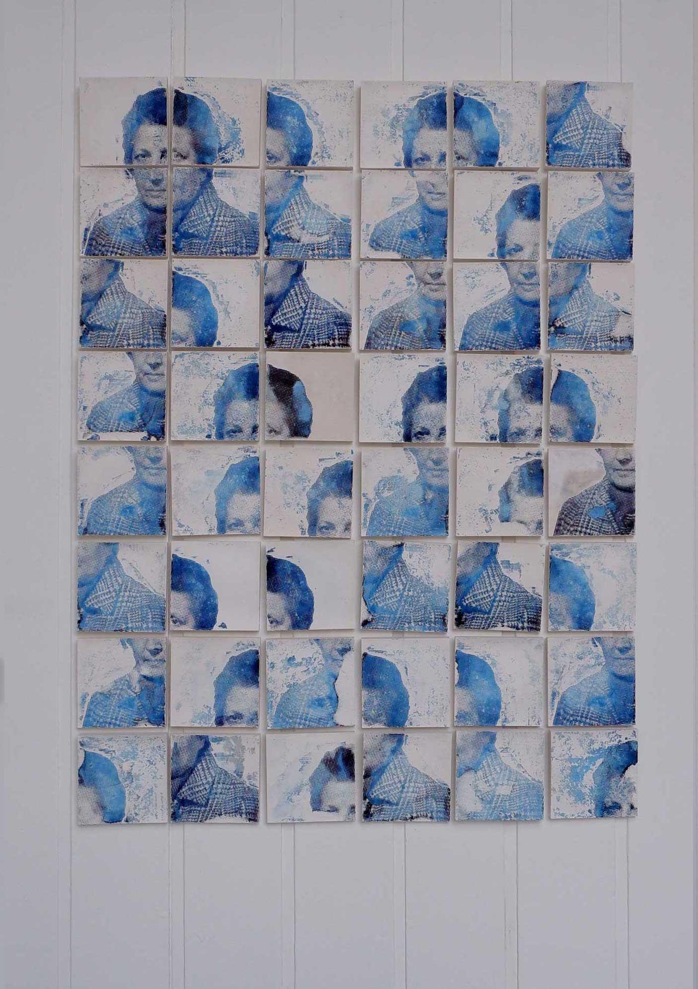 A portrait made up of 96 plaster tiles. Each tile depicts a quarter of a face.