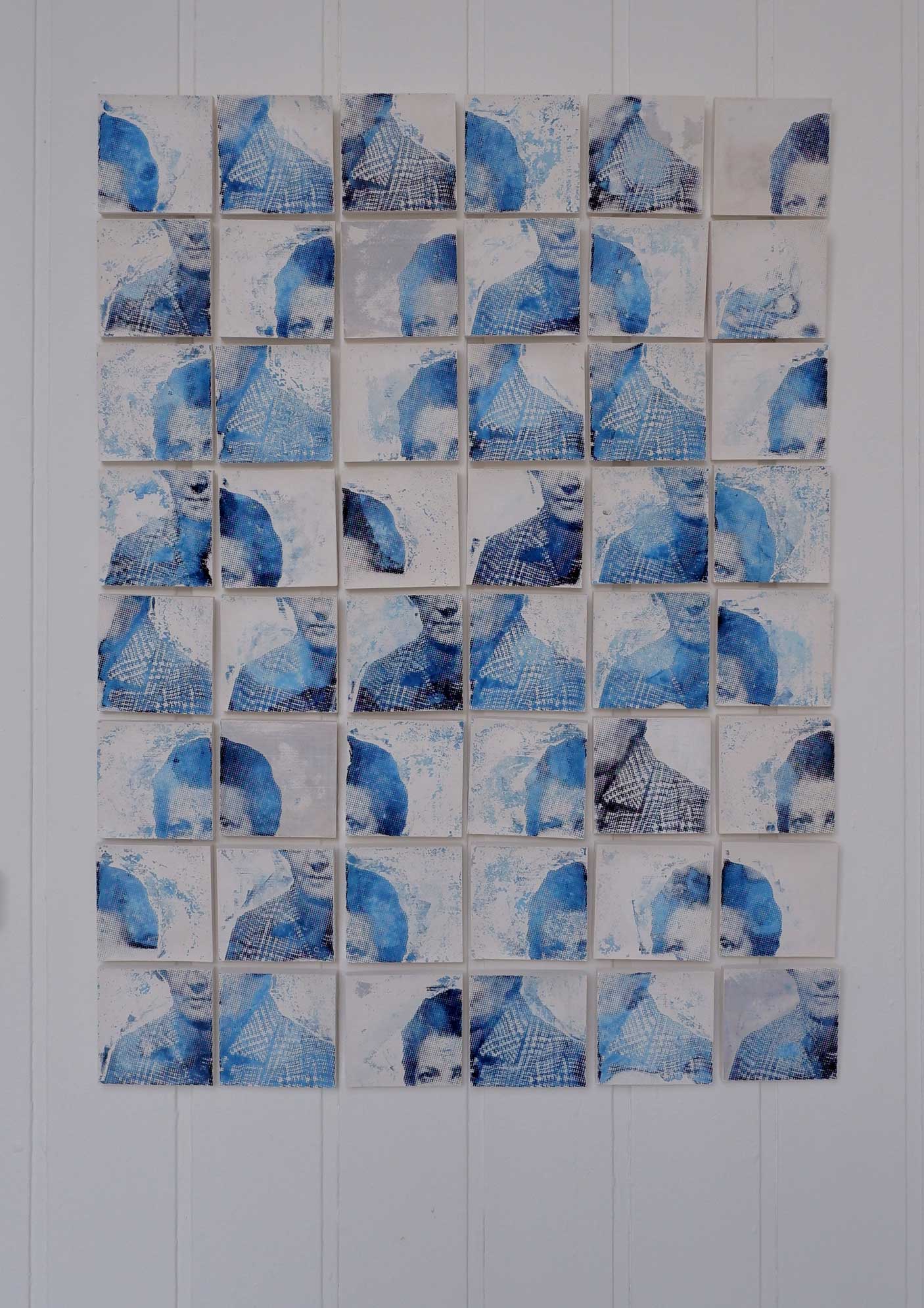A portrait made up of 96 plaster tiles. Each tile depicts a quarter of a face.