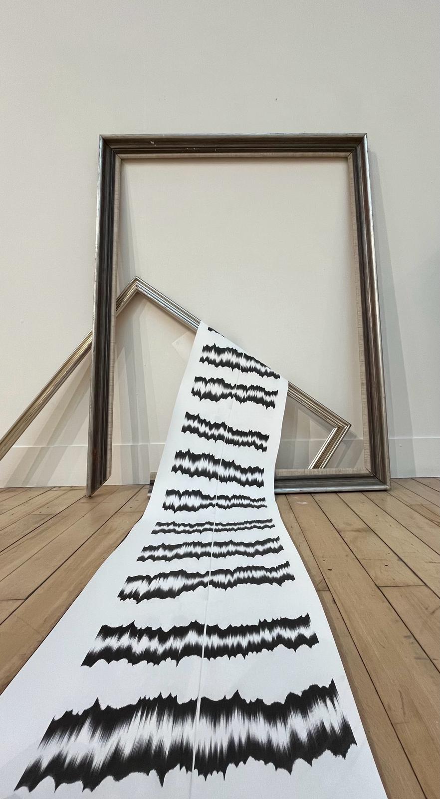 Illustrated wallpaper hanging over wooden frames.