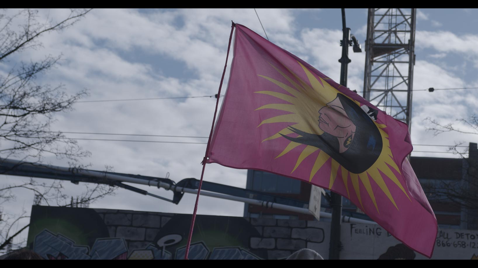 Women's memorial flag being flown against sky 