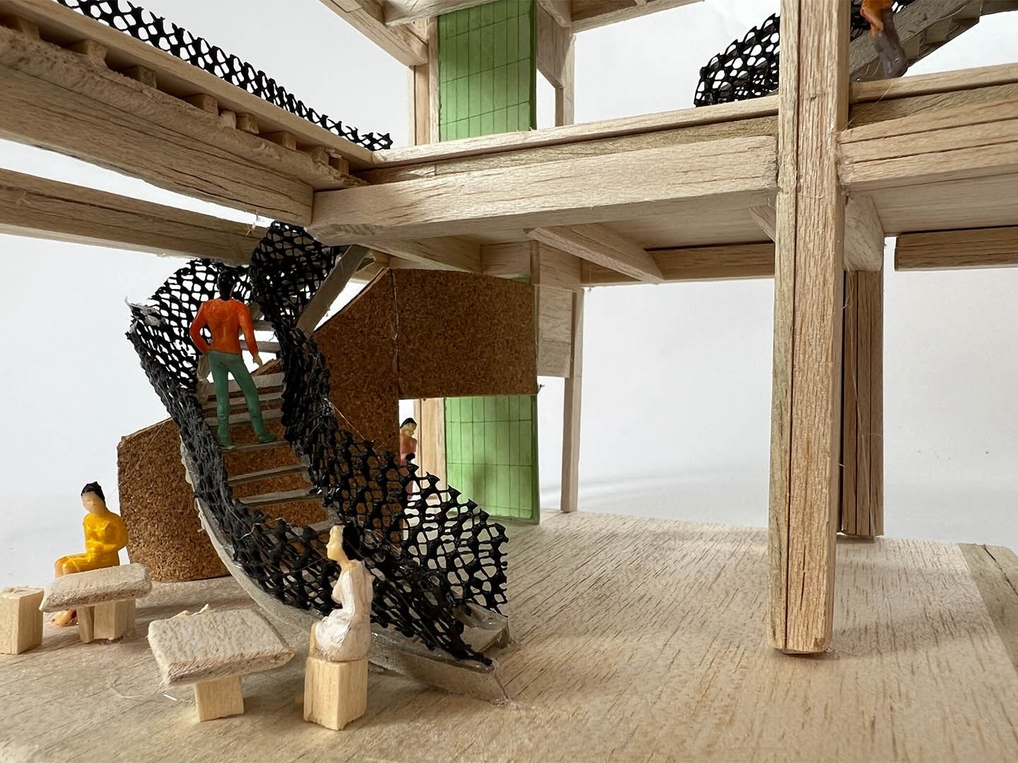 photograph of model showing reception area - spiral staircase, furniture, glulam frame, wooden flooring, and lift shaft in the background.