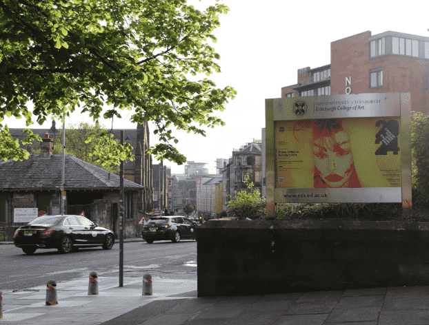 yellow self portrait installed on billboard outside eca