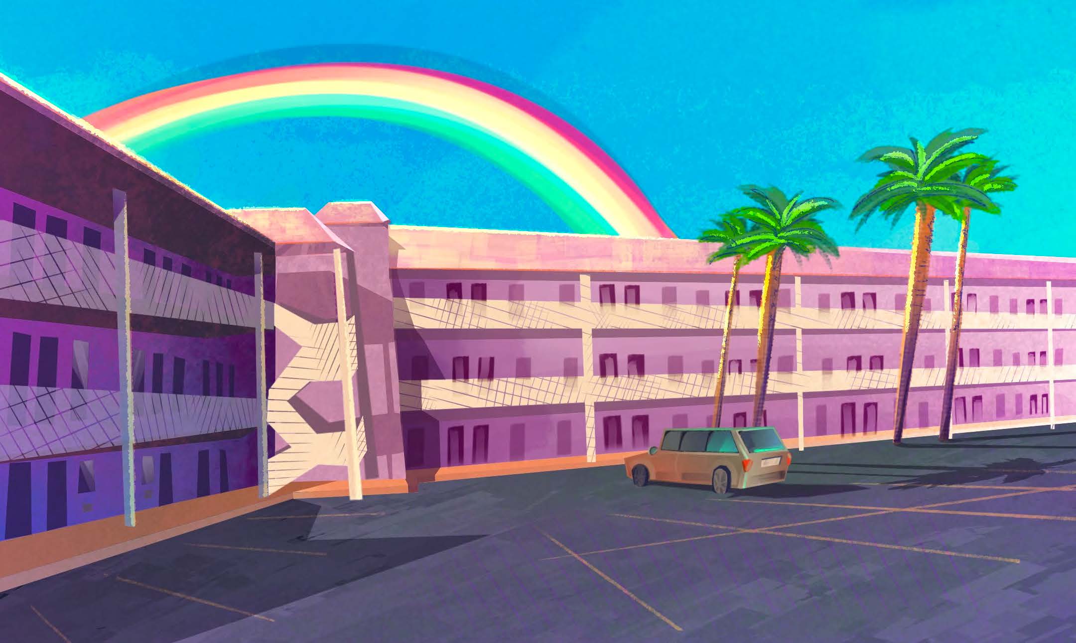 Pink motel building in the sunshine with a rainbow behind it.