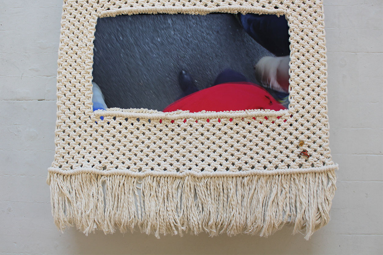 macramé rug with film playing