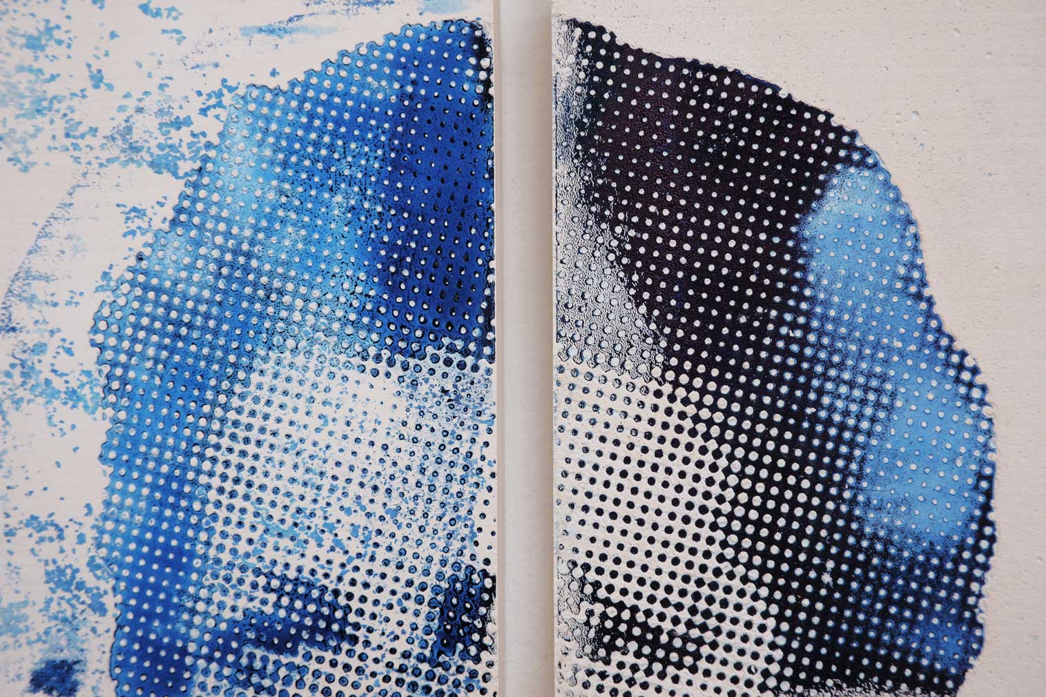  portrait made up of plaster tiles. Each tile depicts a quarter of a face.