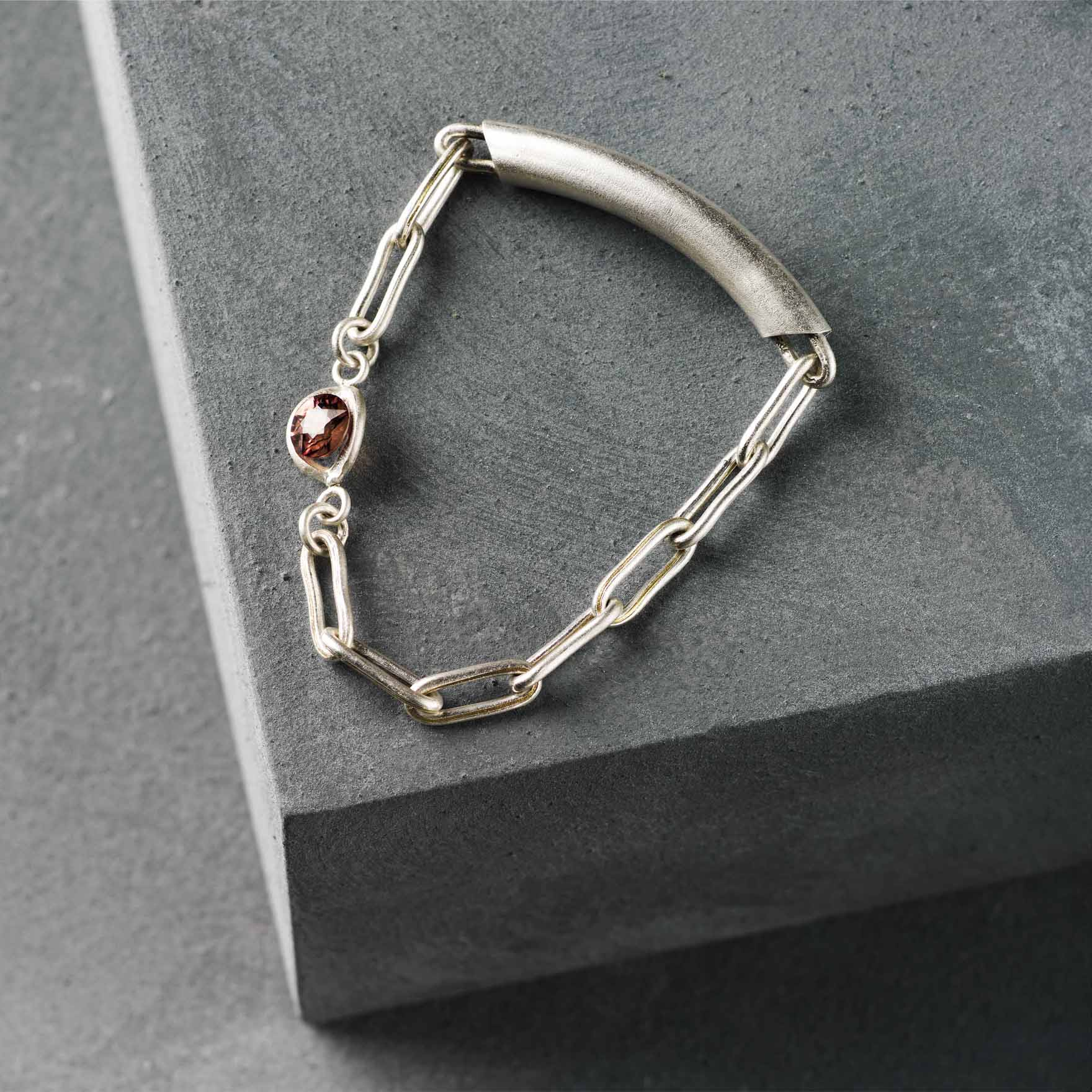 Twisted Tension | Brooch | Silver, Brass and Red Zircon | Flattened Tube with Fixed Brass Twisted Silver Chain and Tension Set Stone