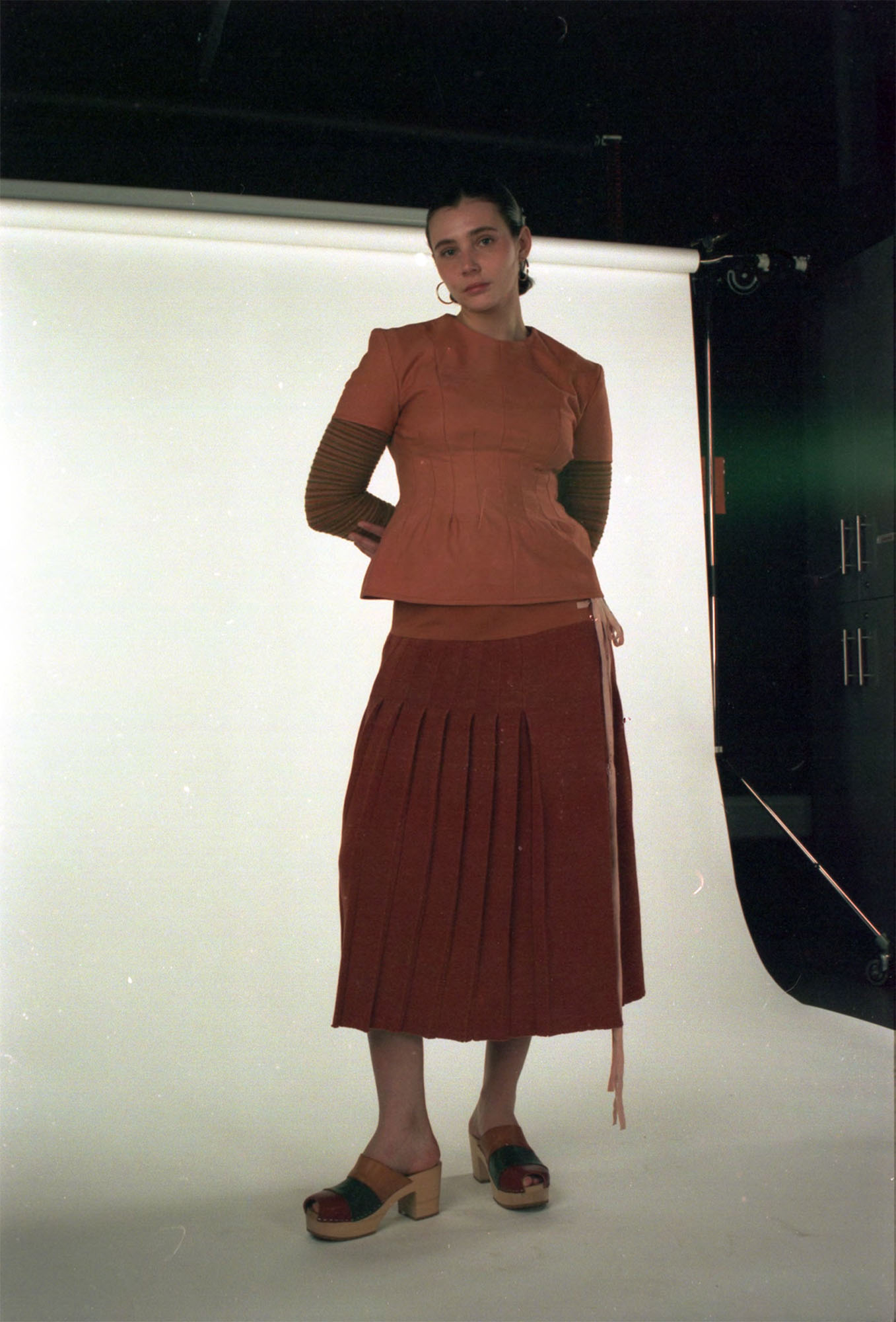 Wool top and knitted kilt dyed with madder, with striped base layer knitted with dyed scrap yarns.