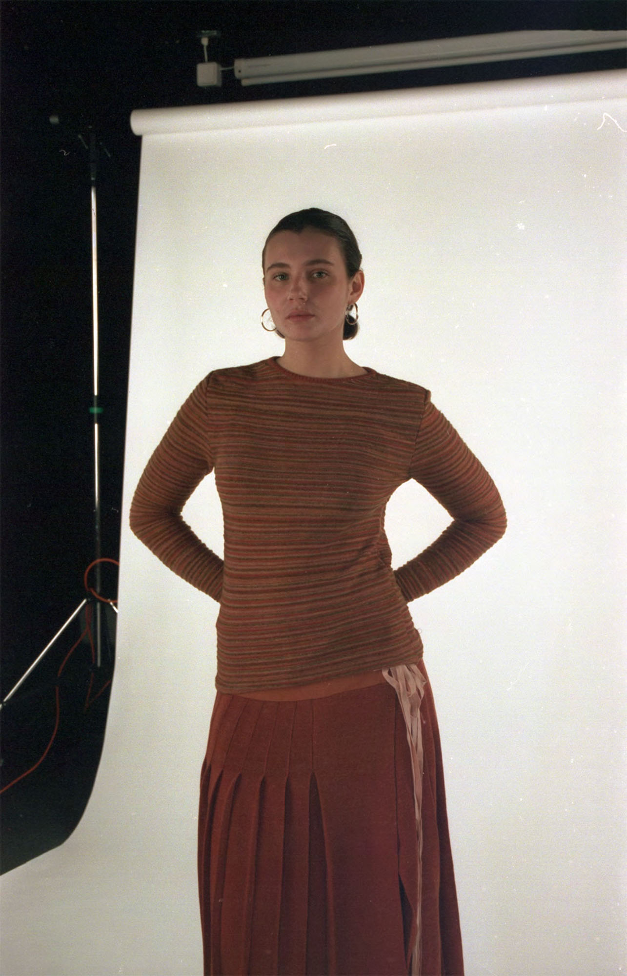 Knitted kilt dyed with madder, with striped base layer knitted with dyed scrap yarns.