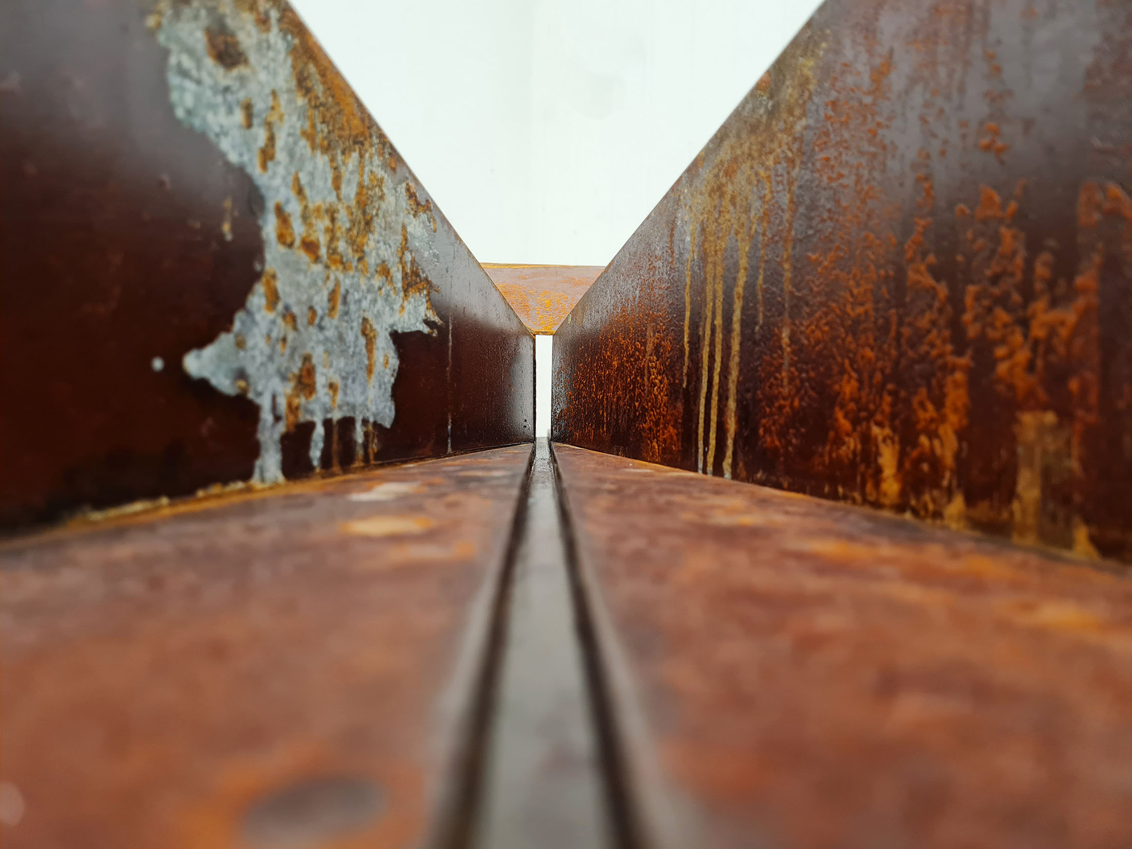 rusted steel sculpture, close up, resembling doorway