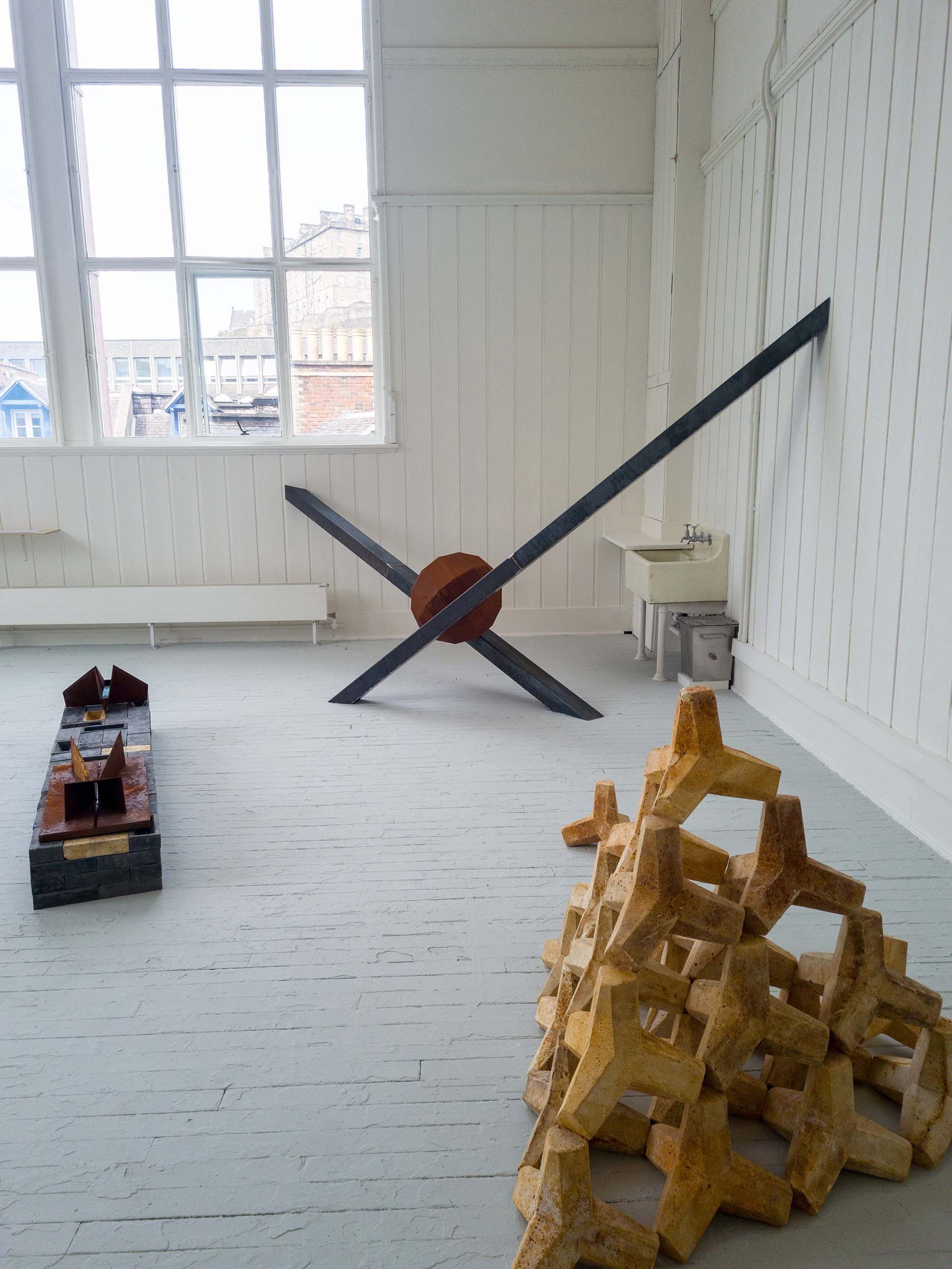 Degree show space showcasing steel sculptures and plaster casts, taken from door way