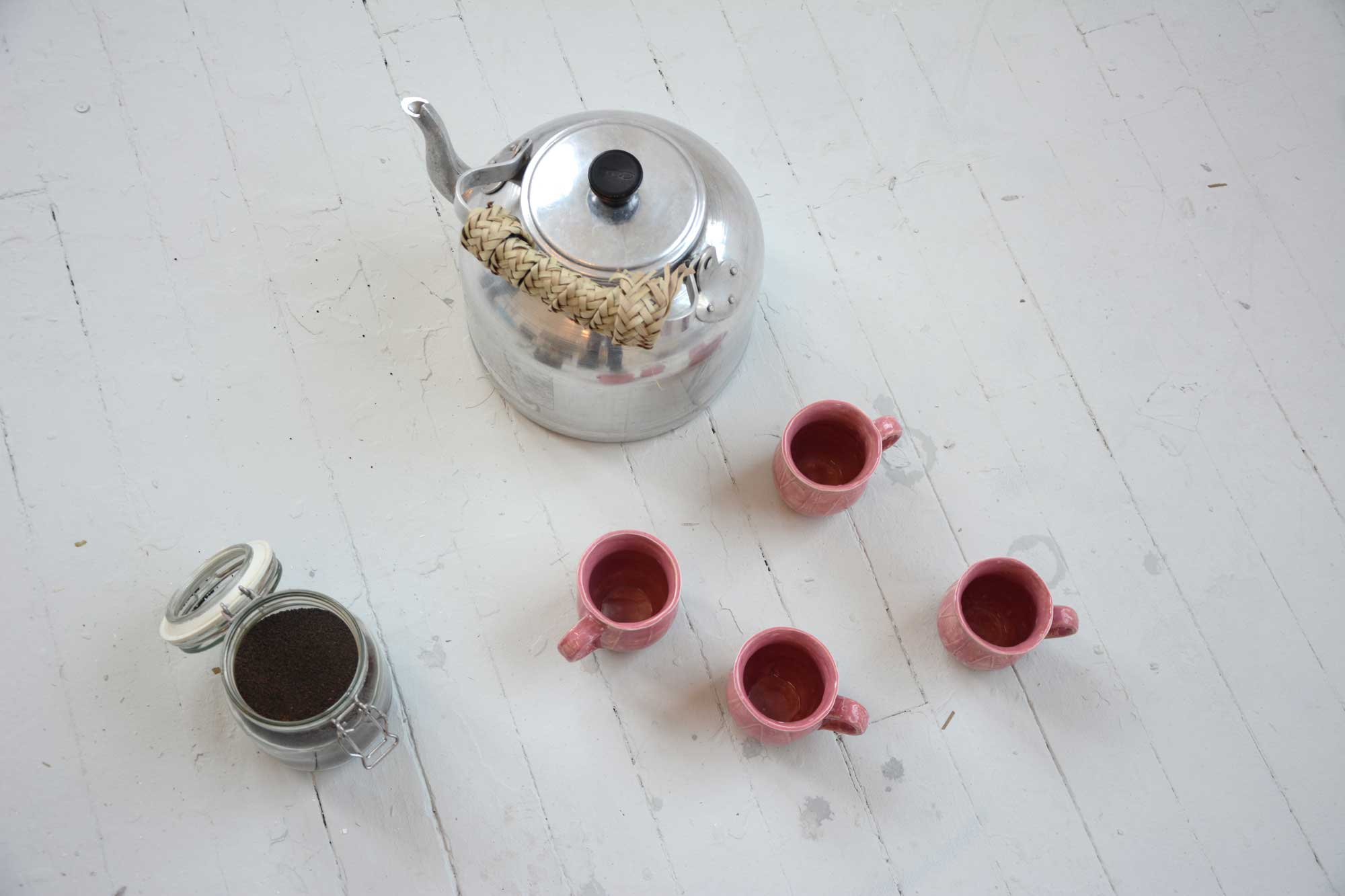 Aluminium Tea pot, tea leaves and pink mugs 
