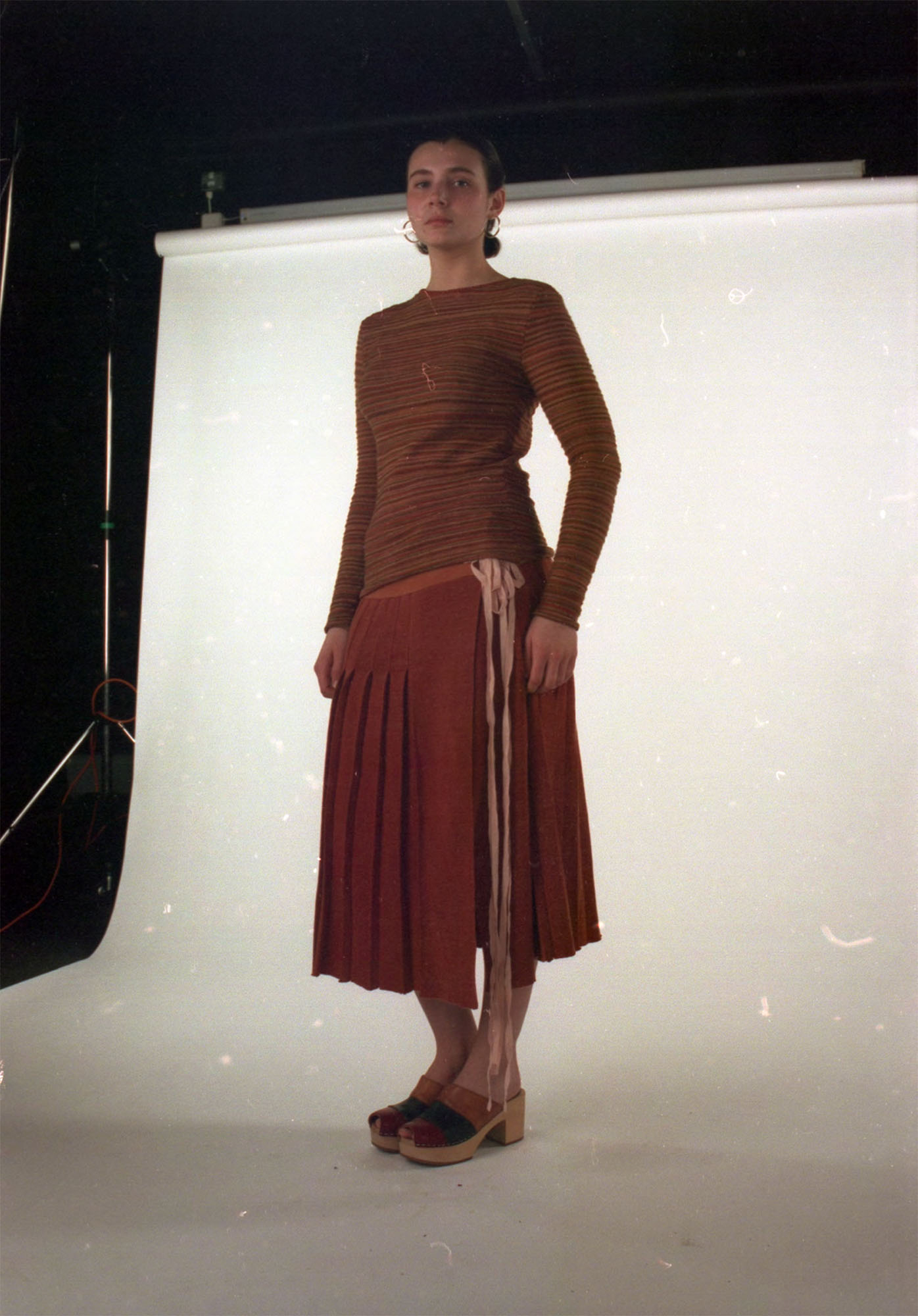 Knitted kilt dyed with madder, with striped base layer knitted with dyed scrap yarns.