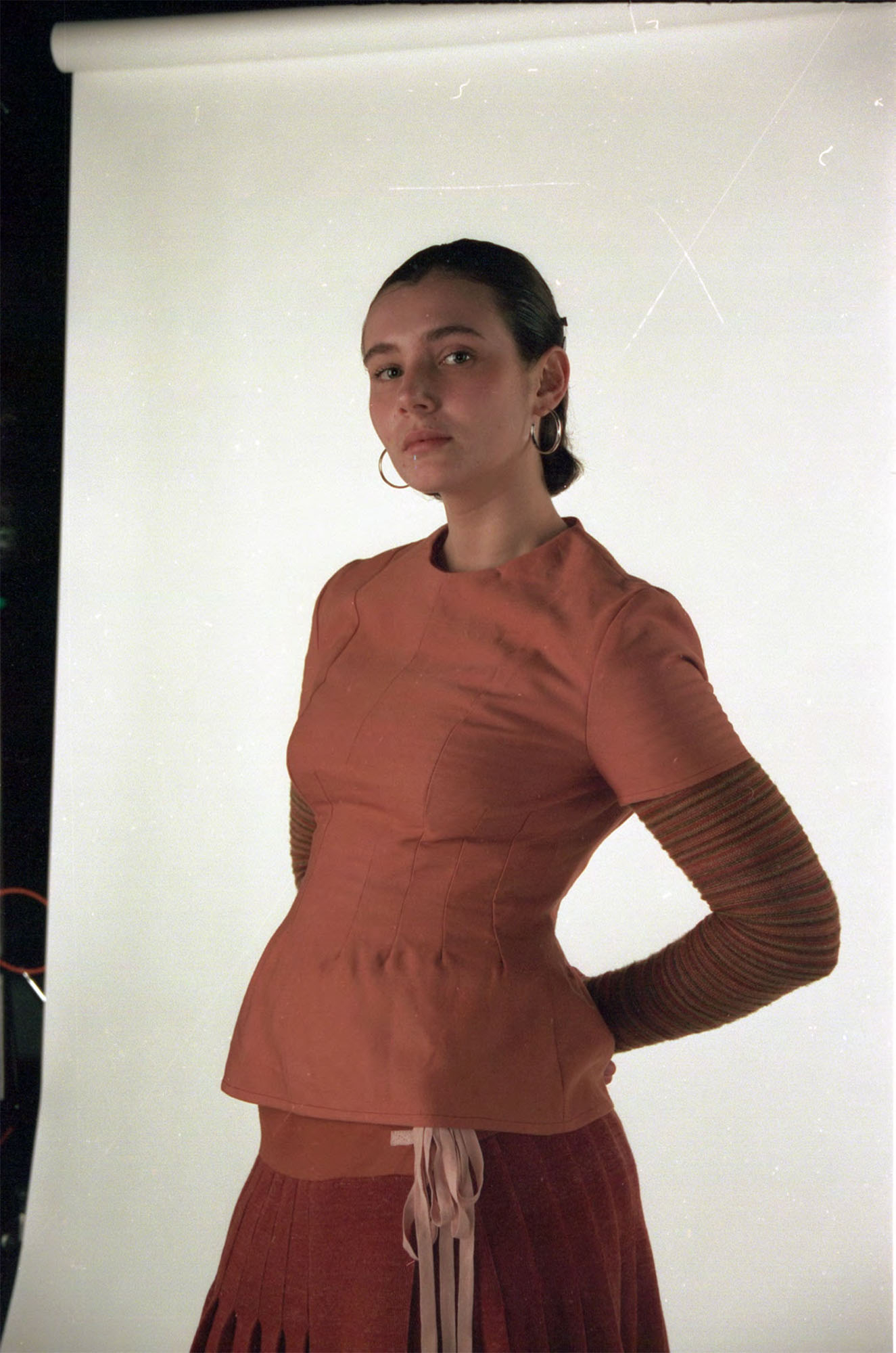 Wool top and knitted kilt dyed with madder, with striped base layer knitted with dyed scrap yarns.