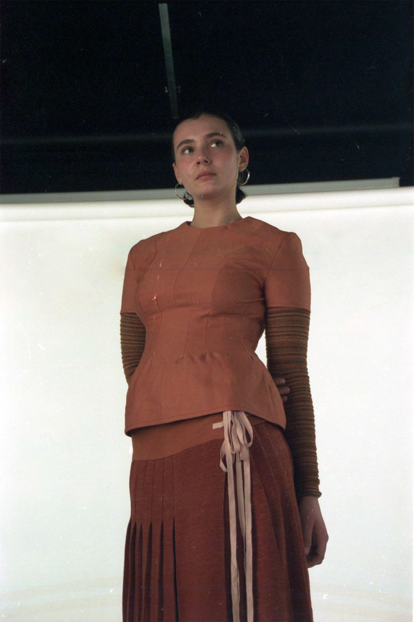 Fitted wool top and knitted kilt dyed with madder, paired with knitted base layer made up of dyed yarn scraps.