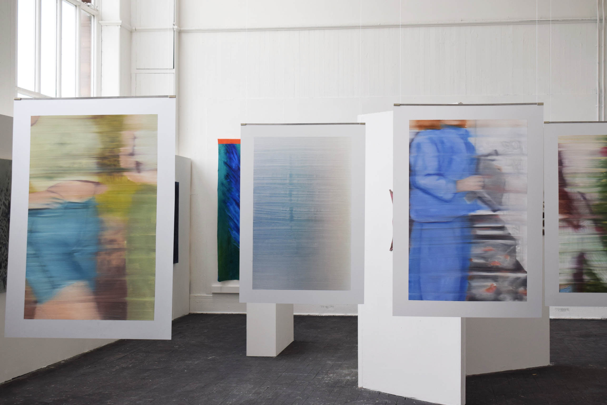 3 paintings installed in the centre of the room