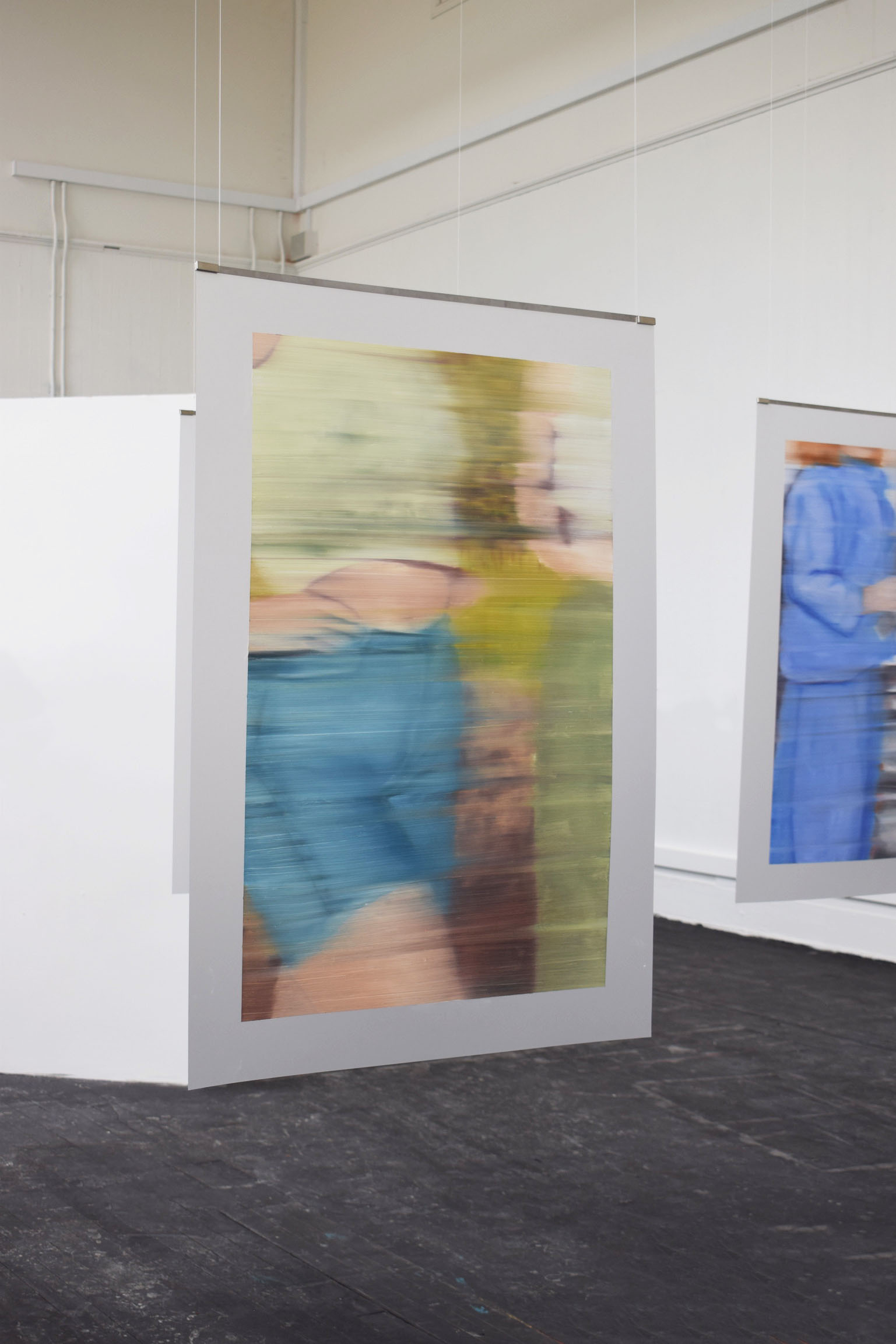 Painting hanging in the centre of a room. 