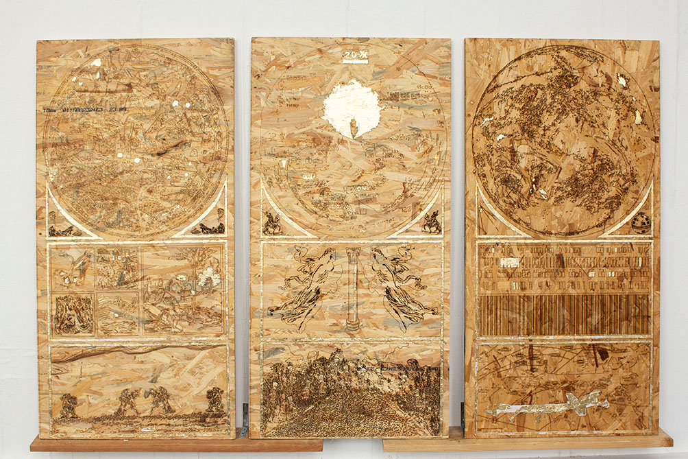 A triptych of laser engraved OSB panels. The panels have been embellished with gold leaf.  