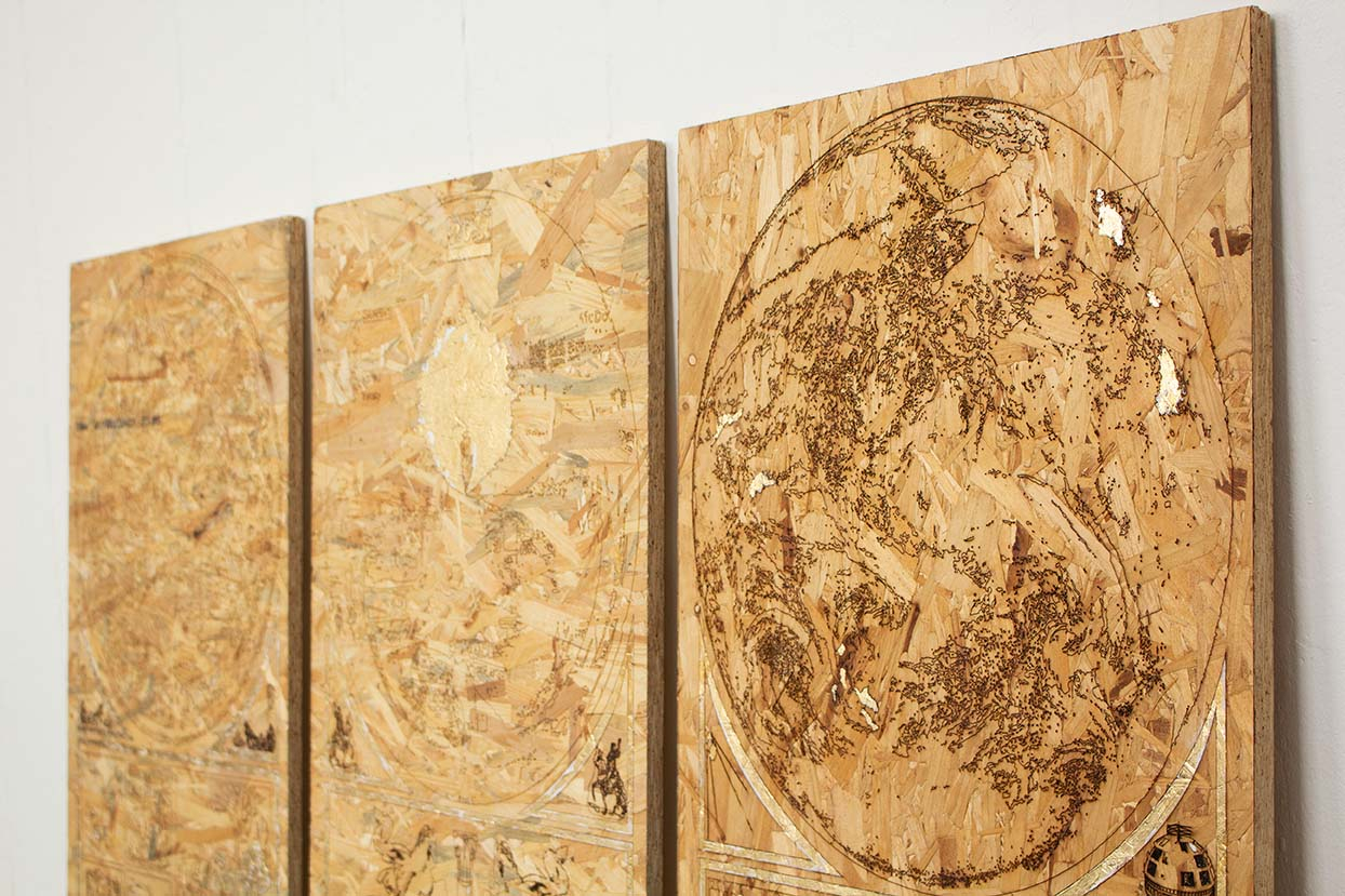 A triptych of laser engraved OSB panels. The panels have been embellished with gold leaf.  