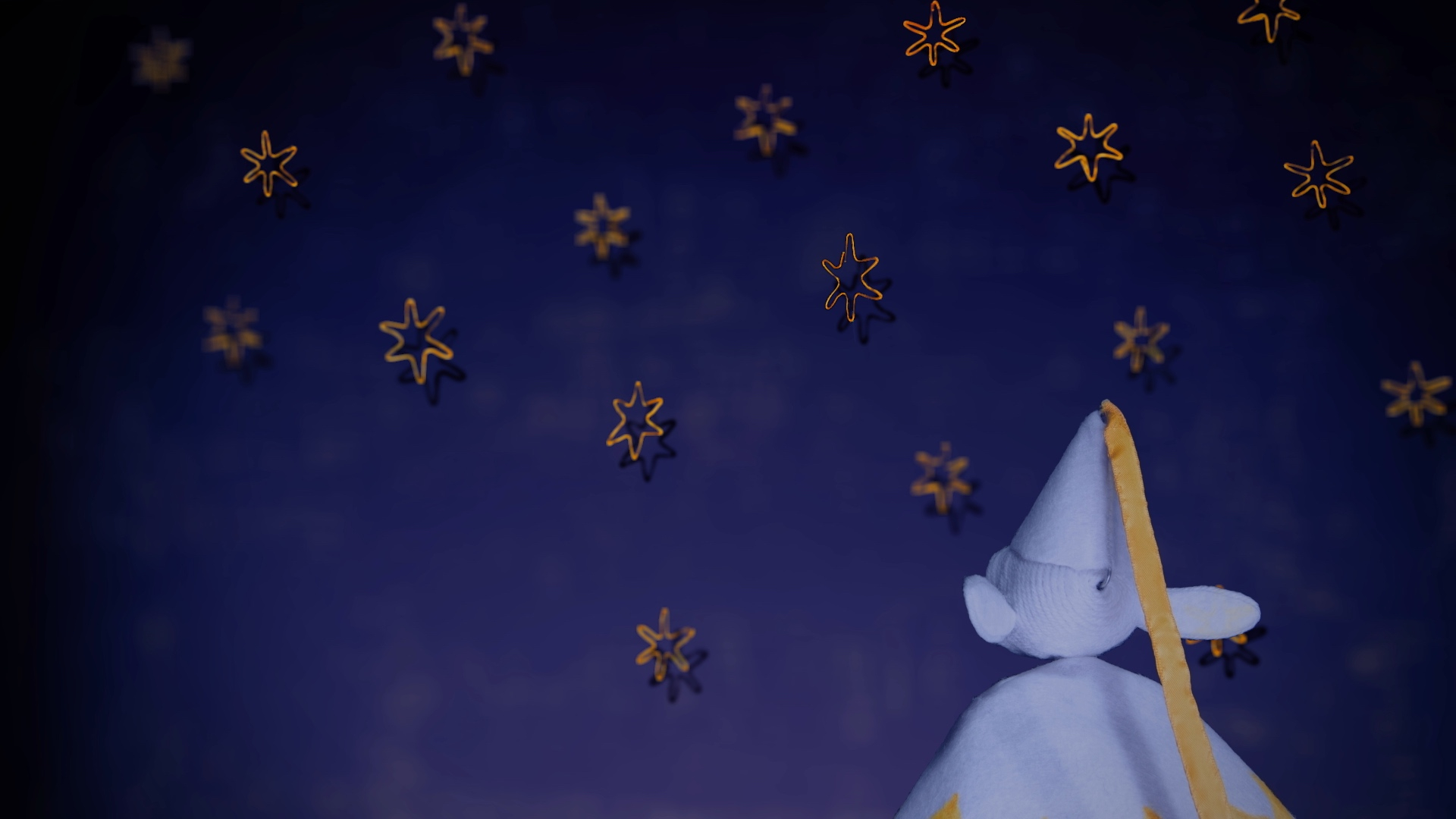 An elf character looks up at golden stars