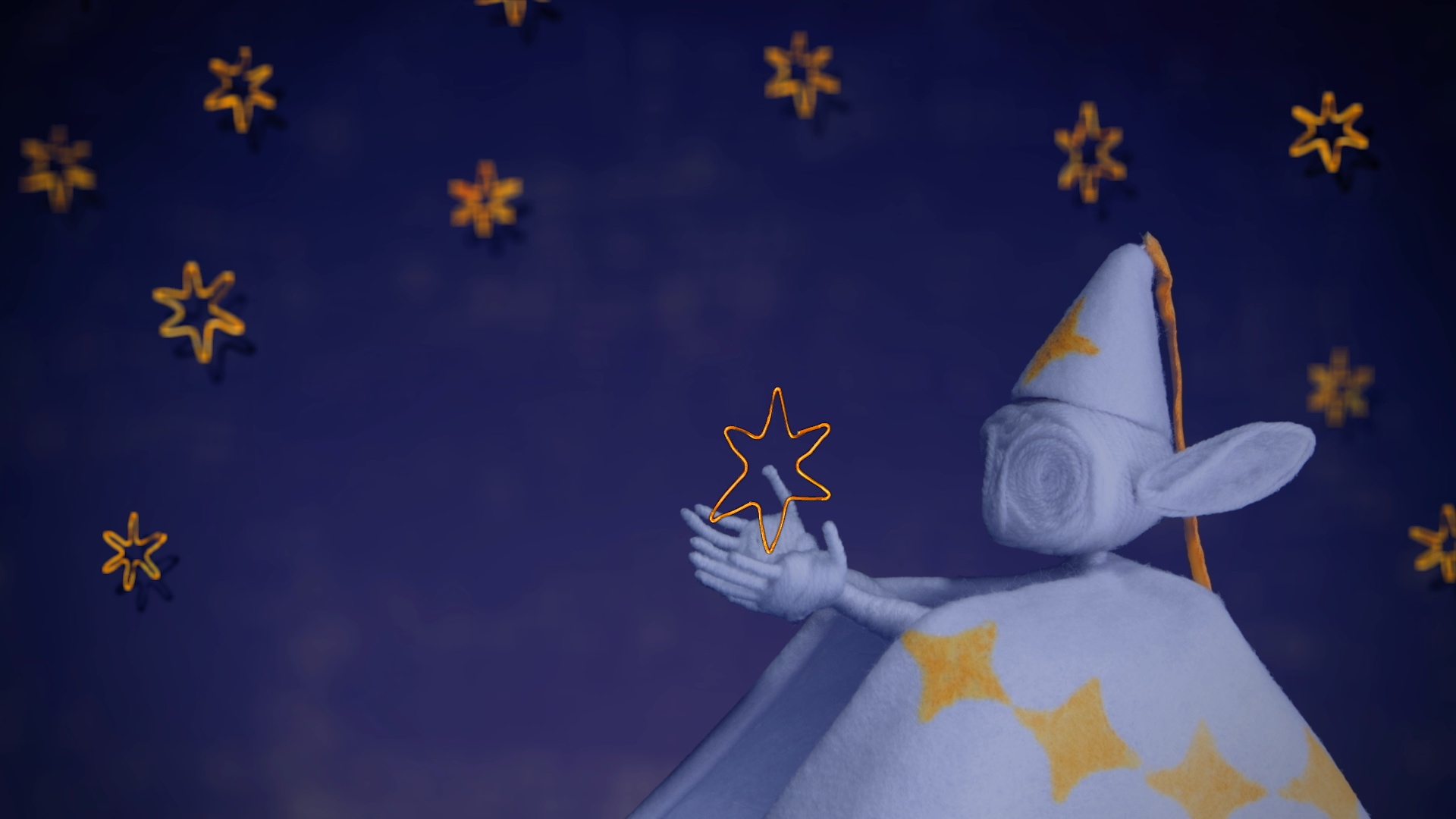 An elf character in a white hat and cape guides a wire star back up to the sky