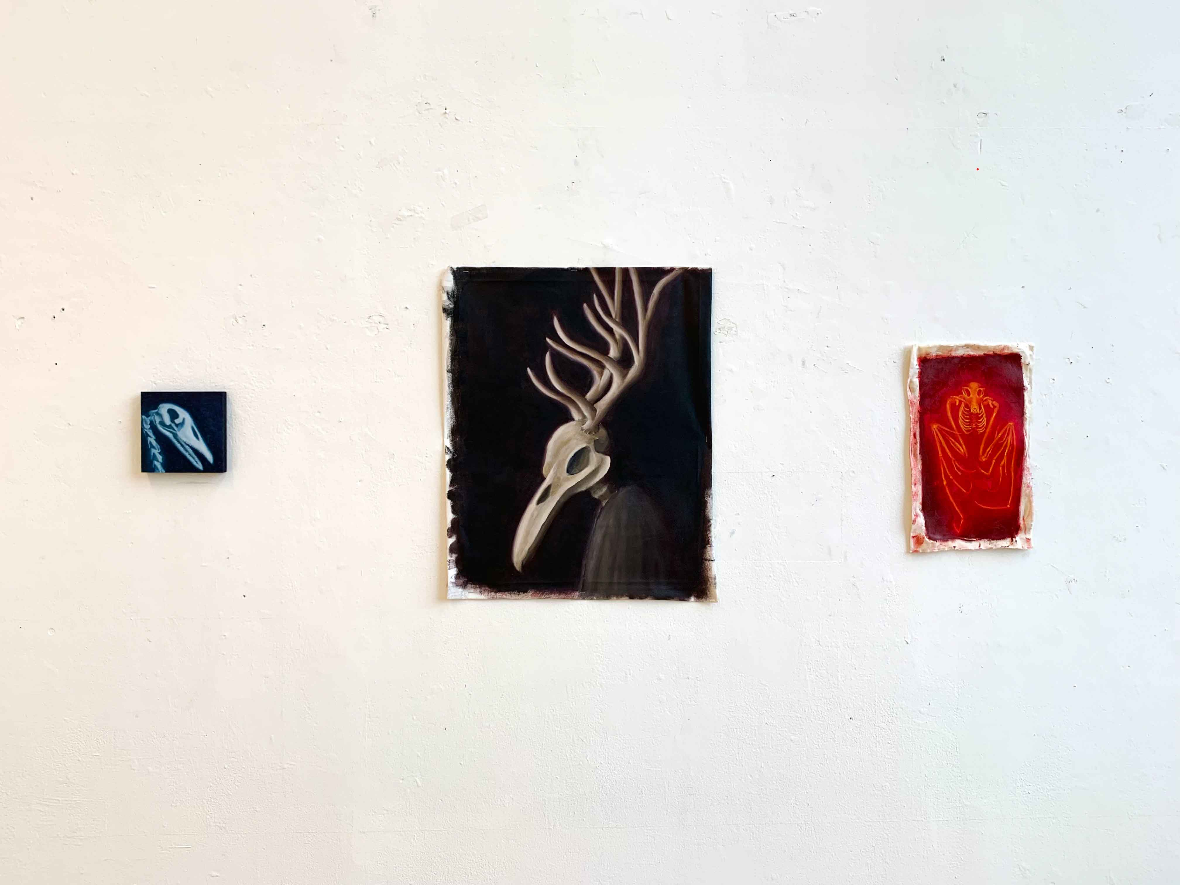 Three separate paintings of animal skeletons, goose, bat and deer/bird hybrid portrait