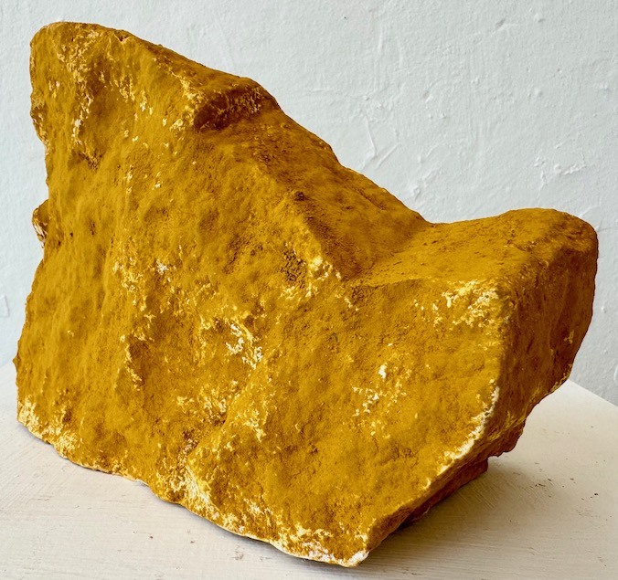 Rock from the Radical Road, 2024. Yellow ochre pigment on plaster. 