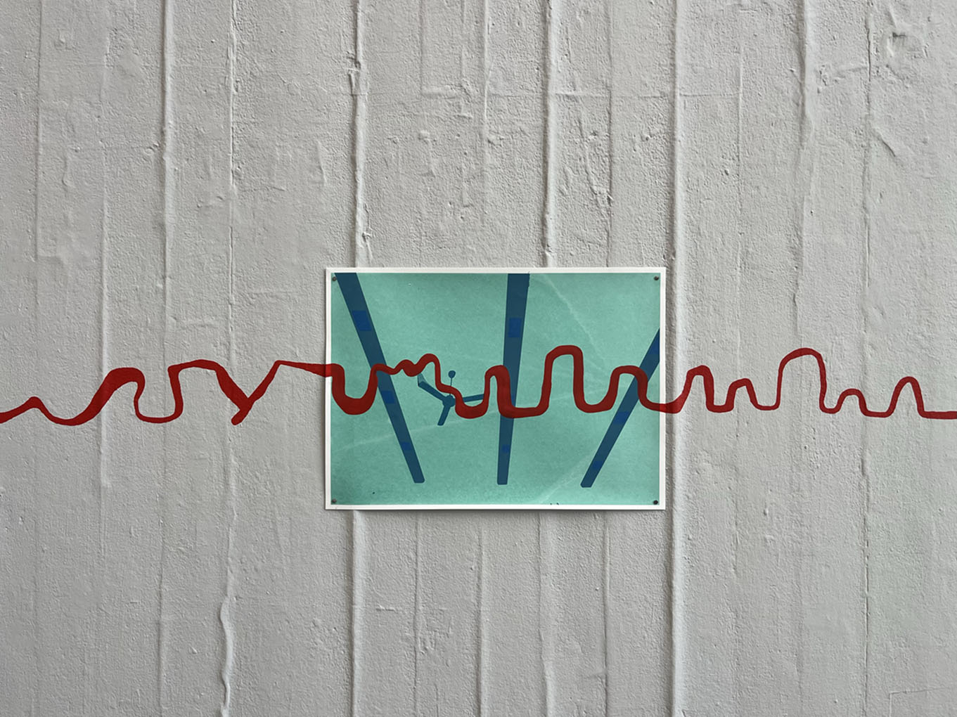 Screen print with a painted red line running over the print and the wall.
