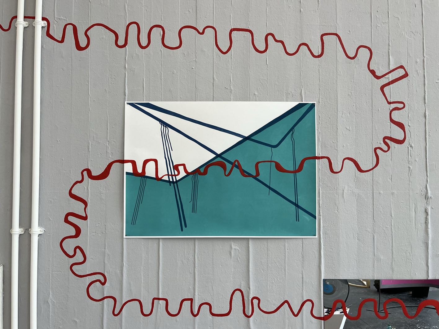 Screen print with a painted red line running over the print and the wall.