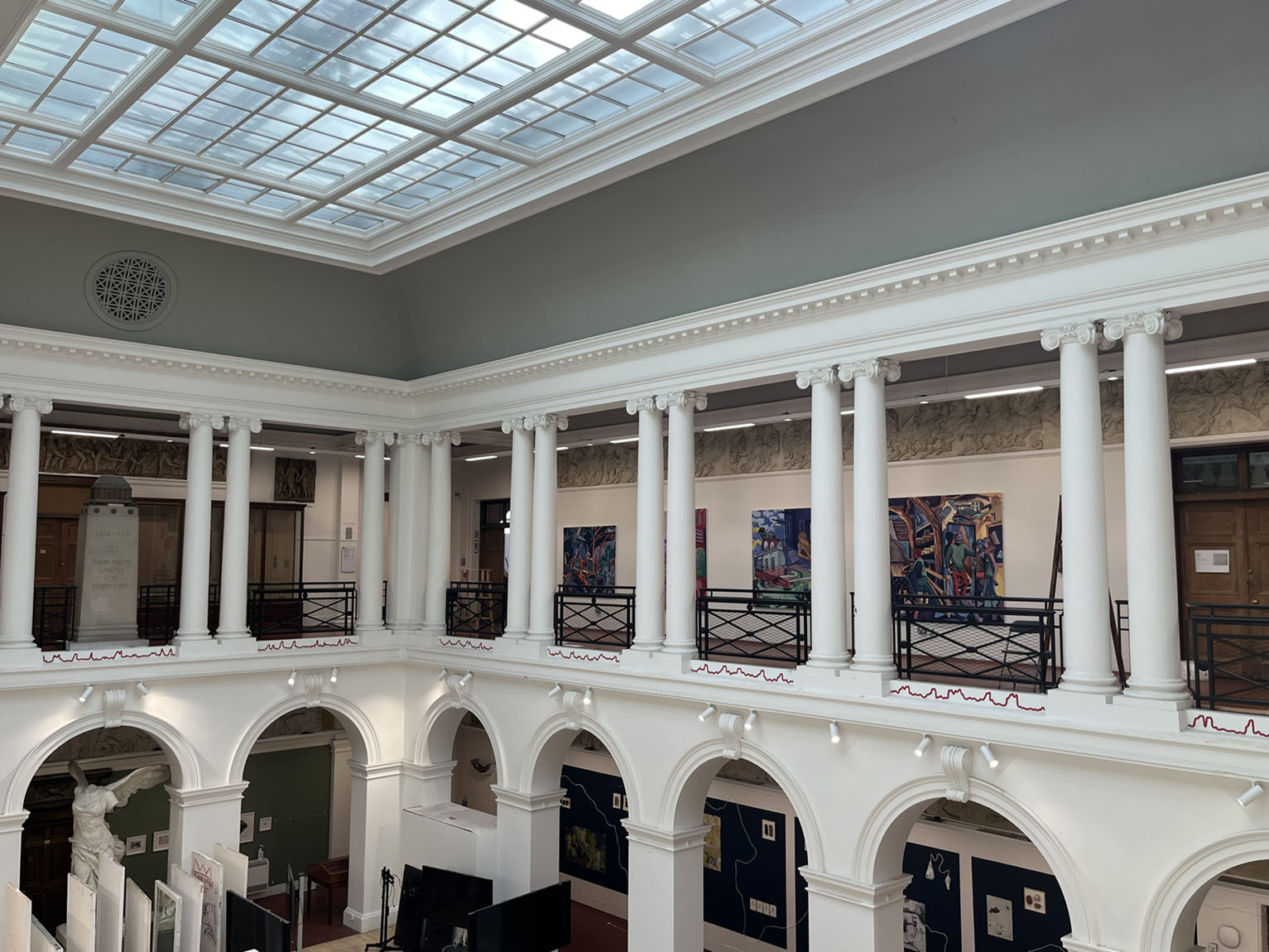 Thin red line along sculpture court balcony.