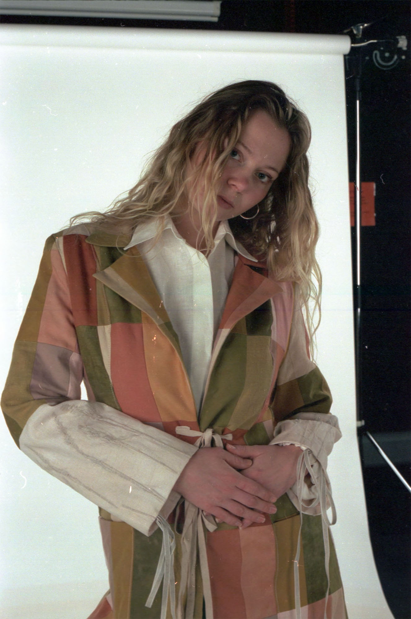 Patchwork coat made up of dyed fabric scraps of linen, wool and cotton, with reeds embedded in the sleeves.