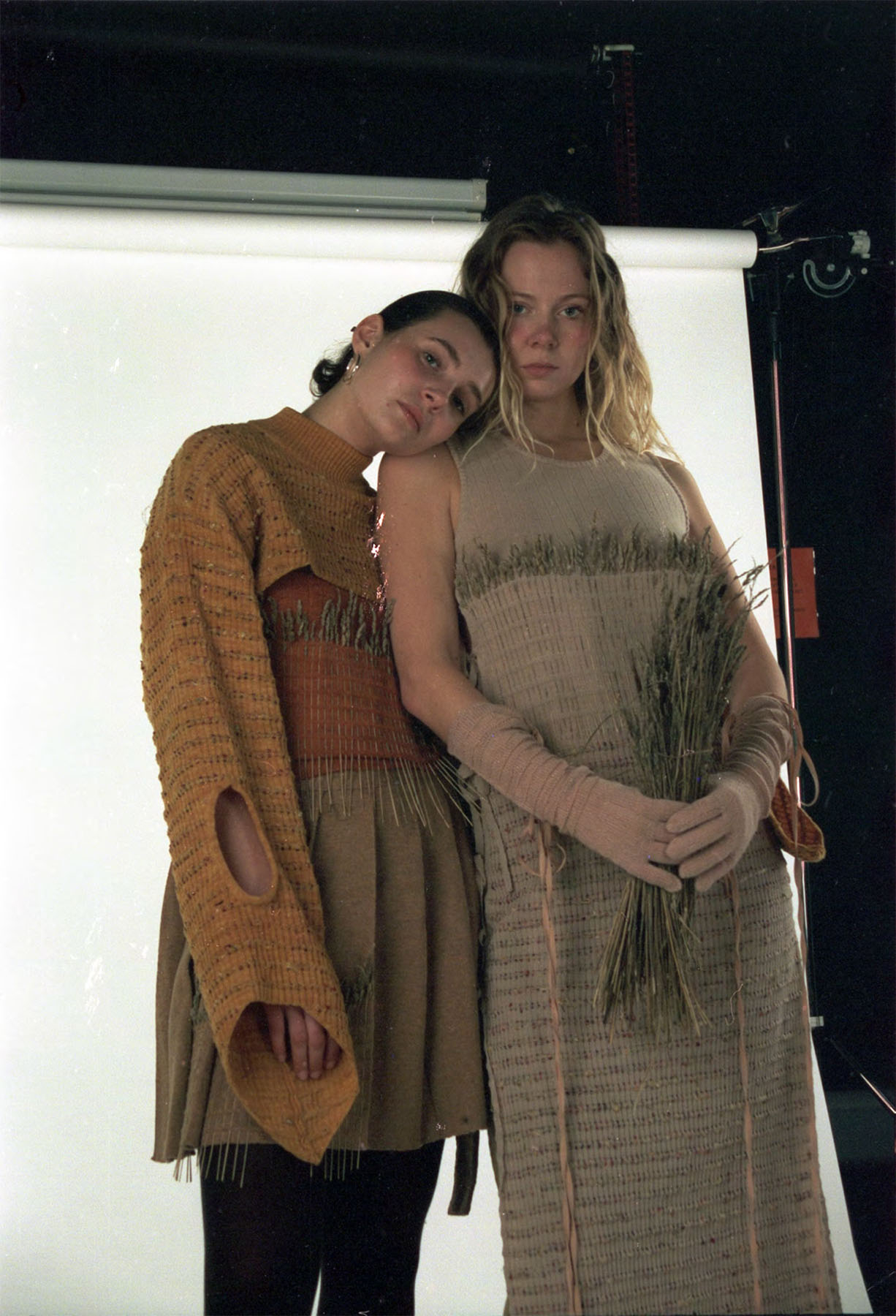 Knitted jumper and vest dyed with yellow onion skins, knitted skirt made from undid cashmere and silk, Knitted dress dyed with avocado pits, paired with linen trousers dyed with red onion skins.