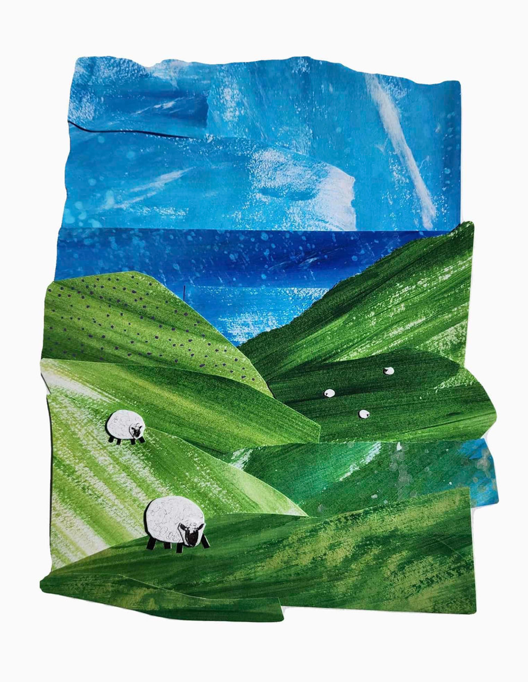 Paper collage of sheep grazing on hills leading to the sea