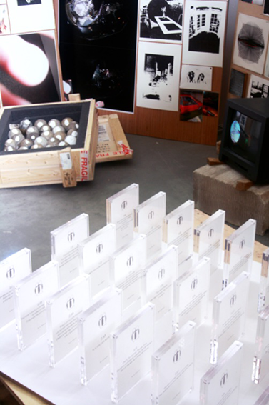 A series of acrylic tablets, highly ordered, presented close and in rows, each preserving a drawing. 