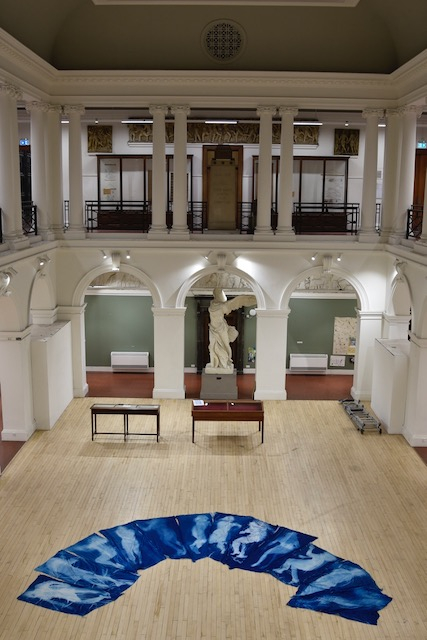 Edinburgh College of Art Sculpture Court with body sized prints laid out on the wooden floor.