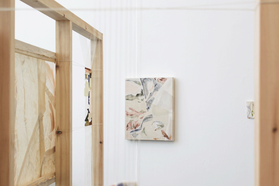 floral painting behind loom, wooden structure on side 