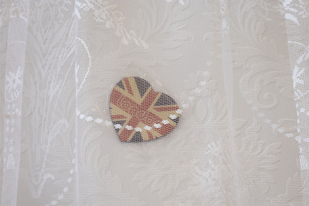 London fridge magnet behind lace curtains