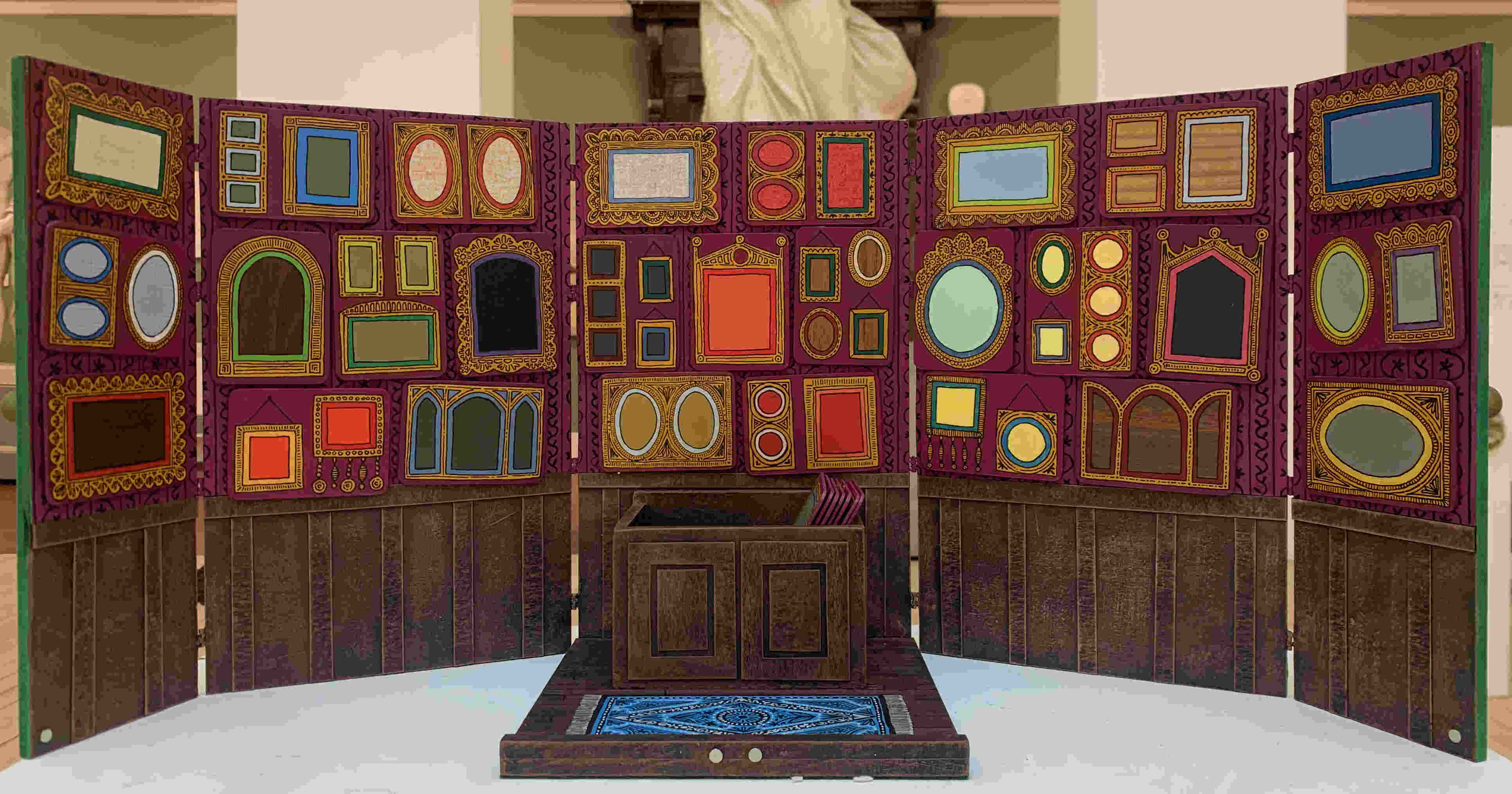 dollhouse salon with colourful frames decorating the wallpapered walls