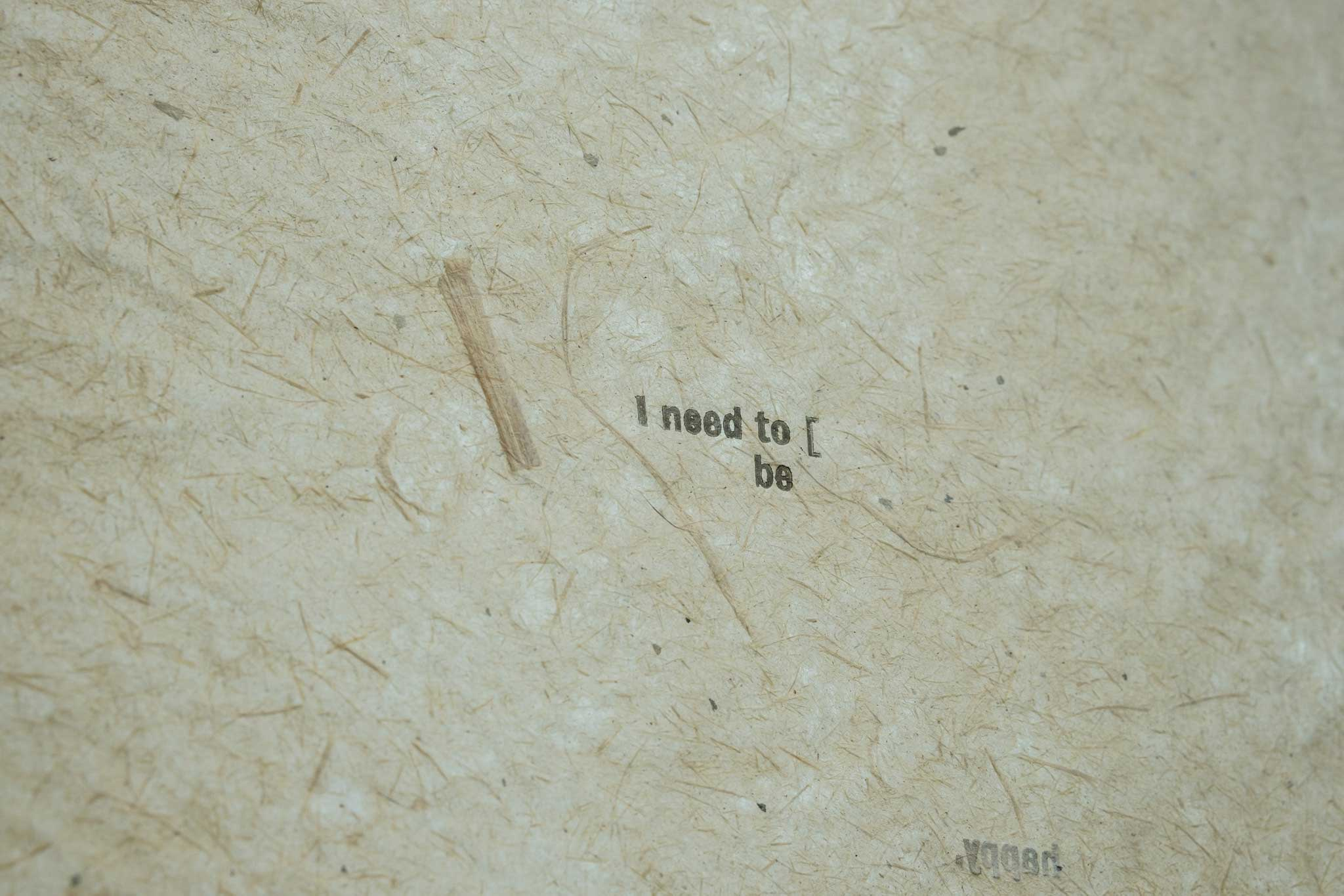 close up of a letterpress print on himalayan balsam fibre paper, saying "I need to be. Happy"