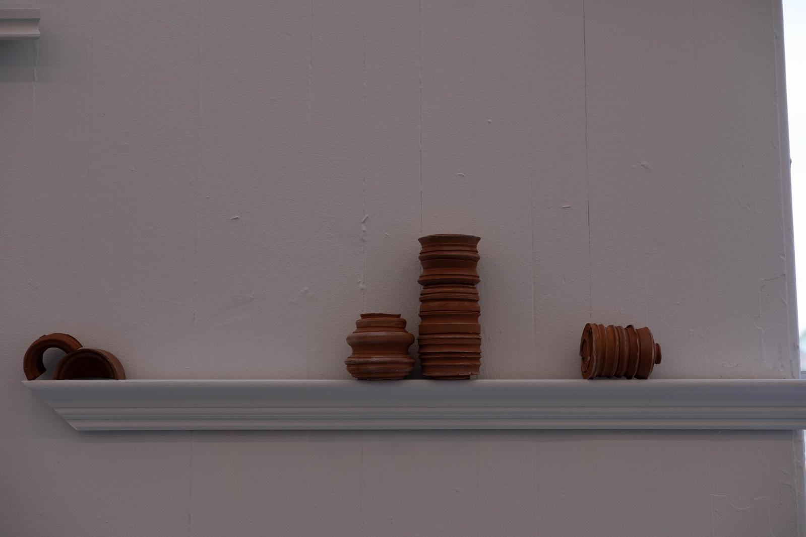 Six bisque-fired terracotta ceramic forms.