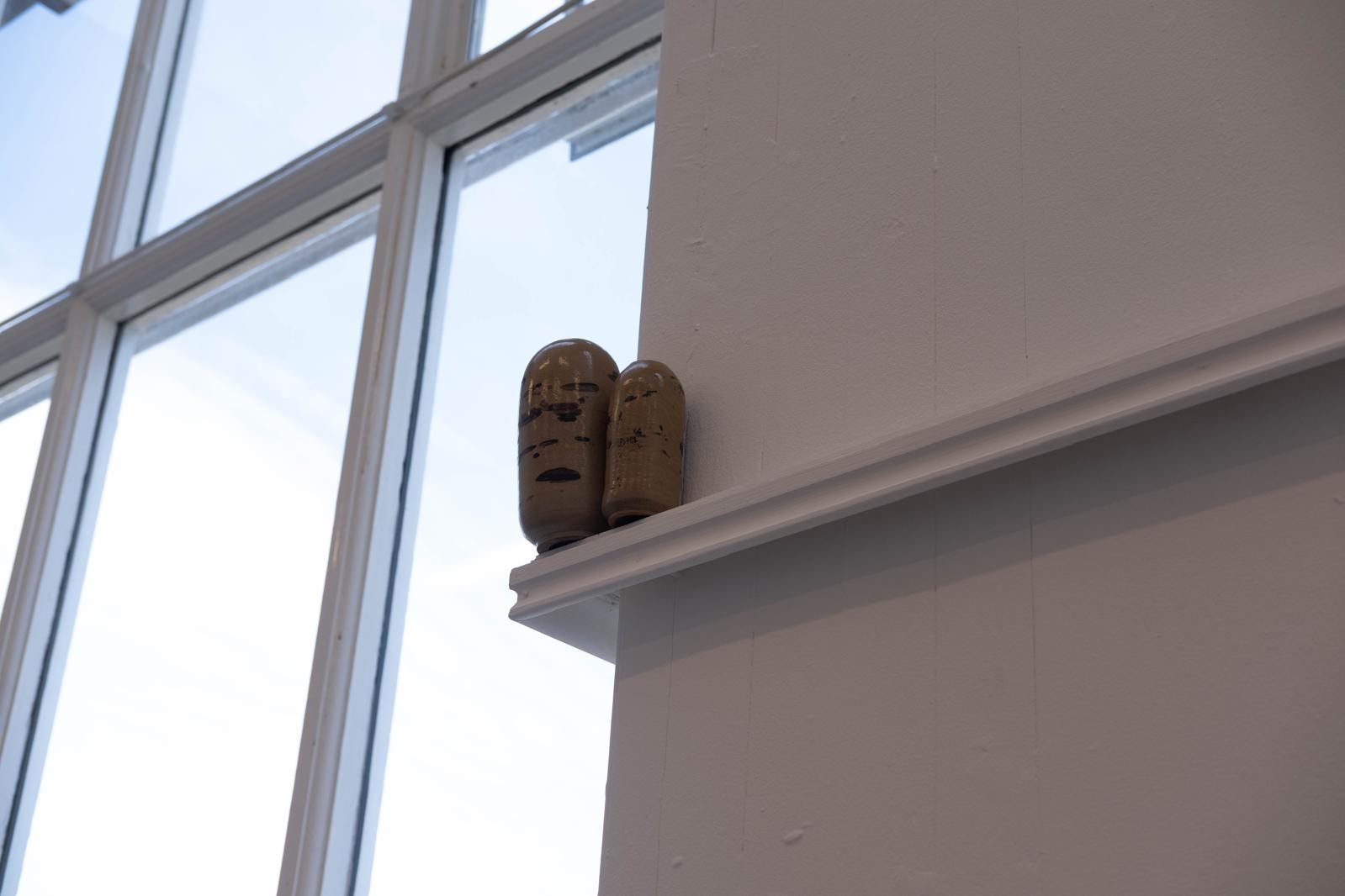 Two ceramic forms with black slip & transparent glaze.