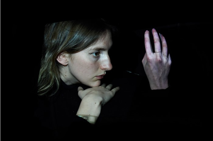 girl looking at her own hand