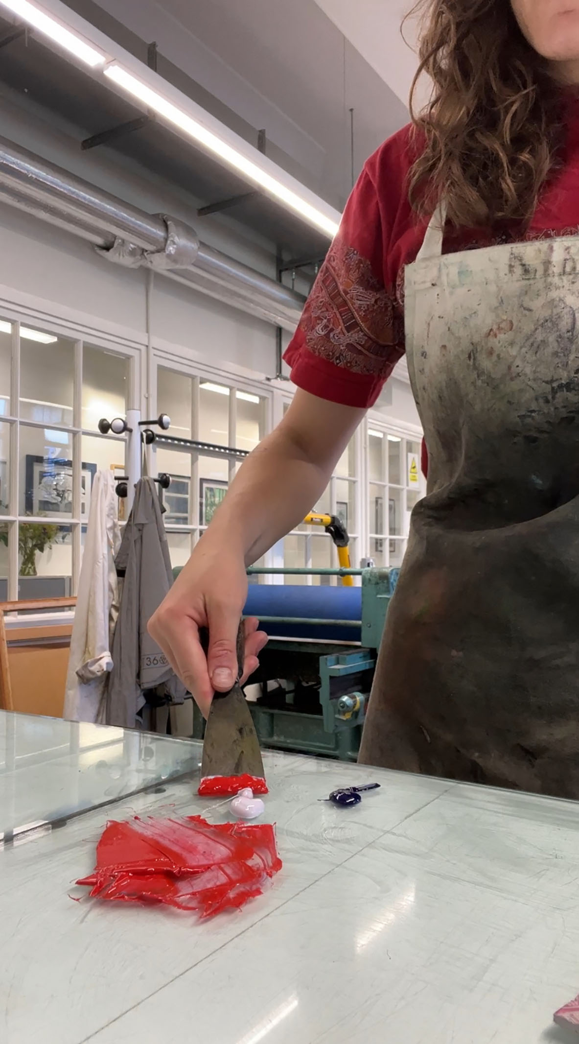Image of Mattie mixing printing inks with a palette knife.