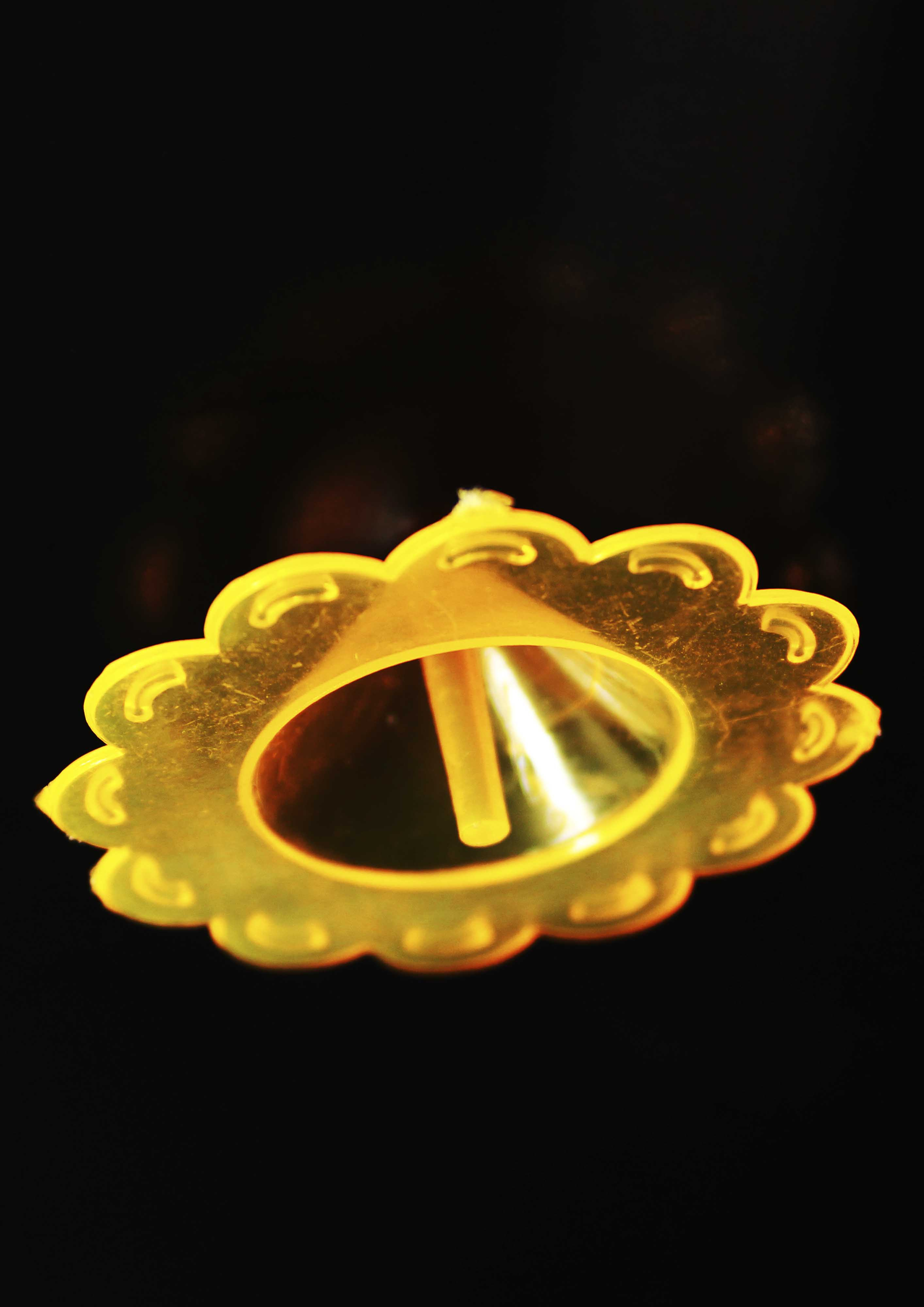Image captures a orange plastic arcade toy spinner